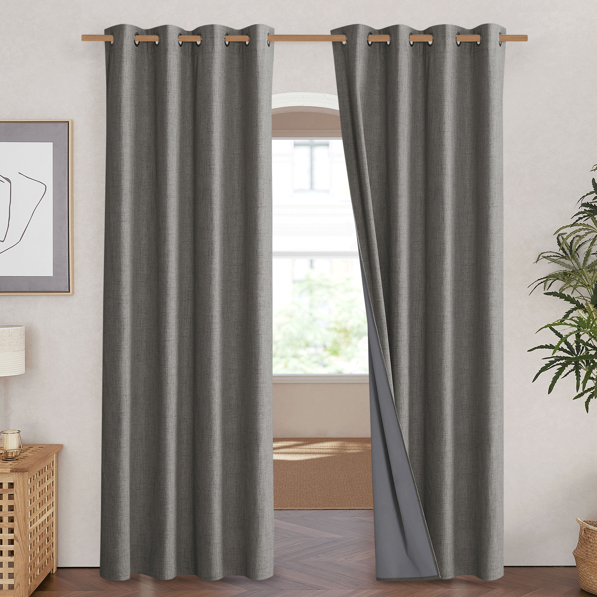 Dark gray linen curtain panel pulled aside to display the smooth, solid gray 100% blackout lining on the back.