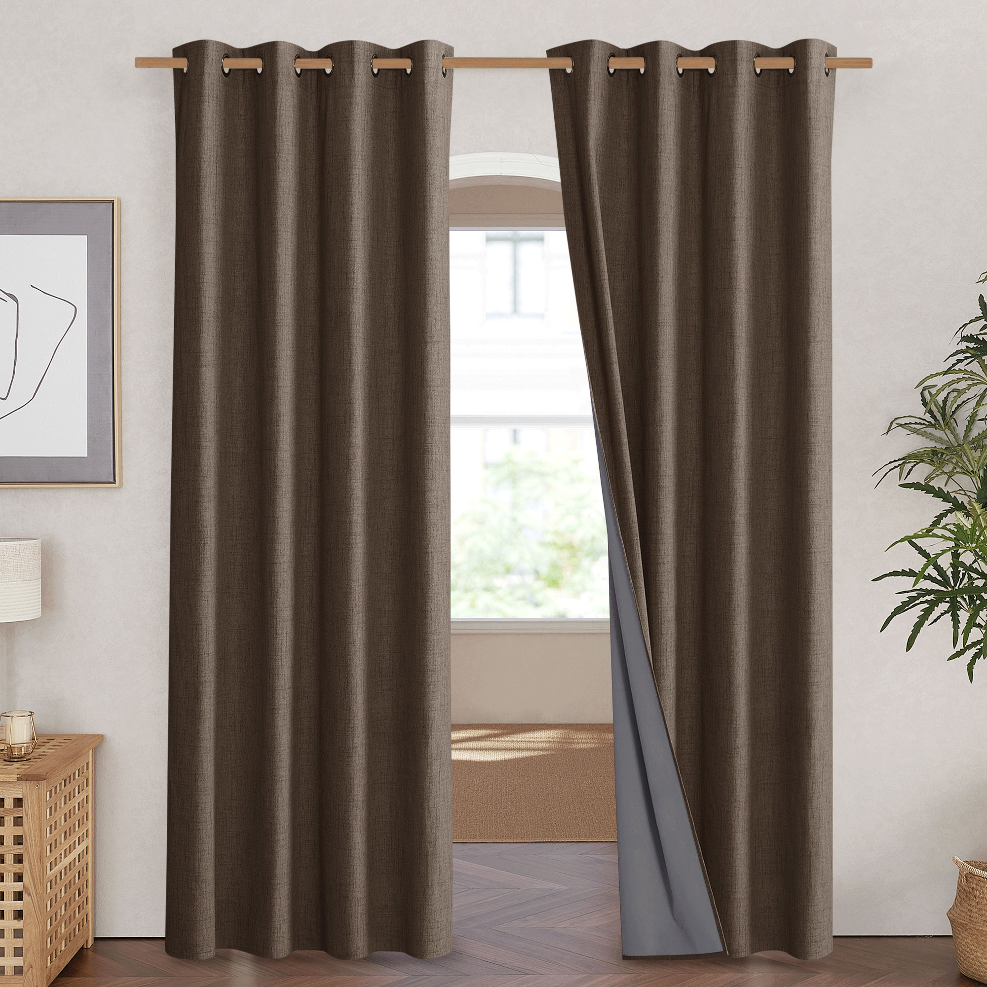 Brown linen blackout curtains with grommets hanging in a doorway, revealing the integrated grey blackout lining.
