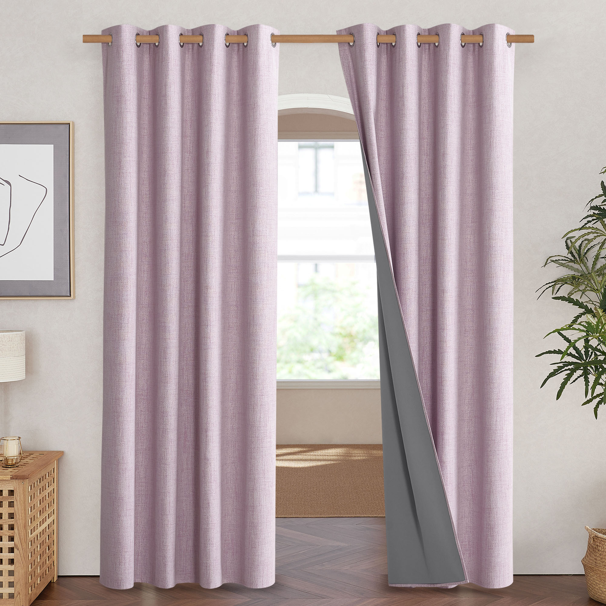 A pink linen curtain pulled back to show the dark grey sewn-in liner that provides 100% blackout.