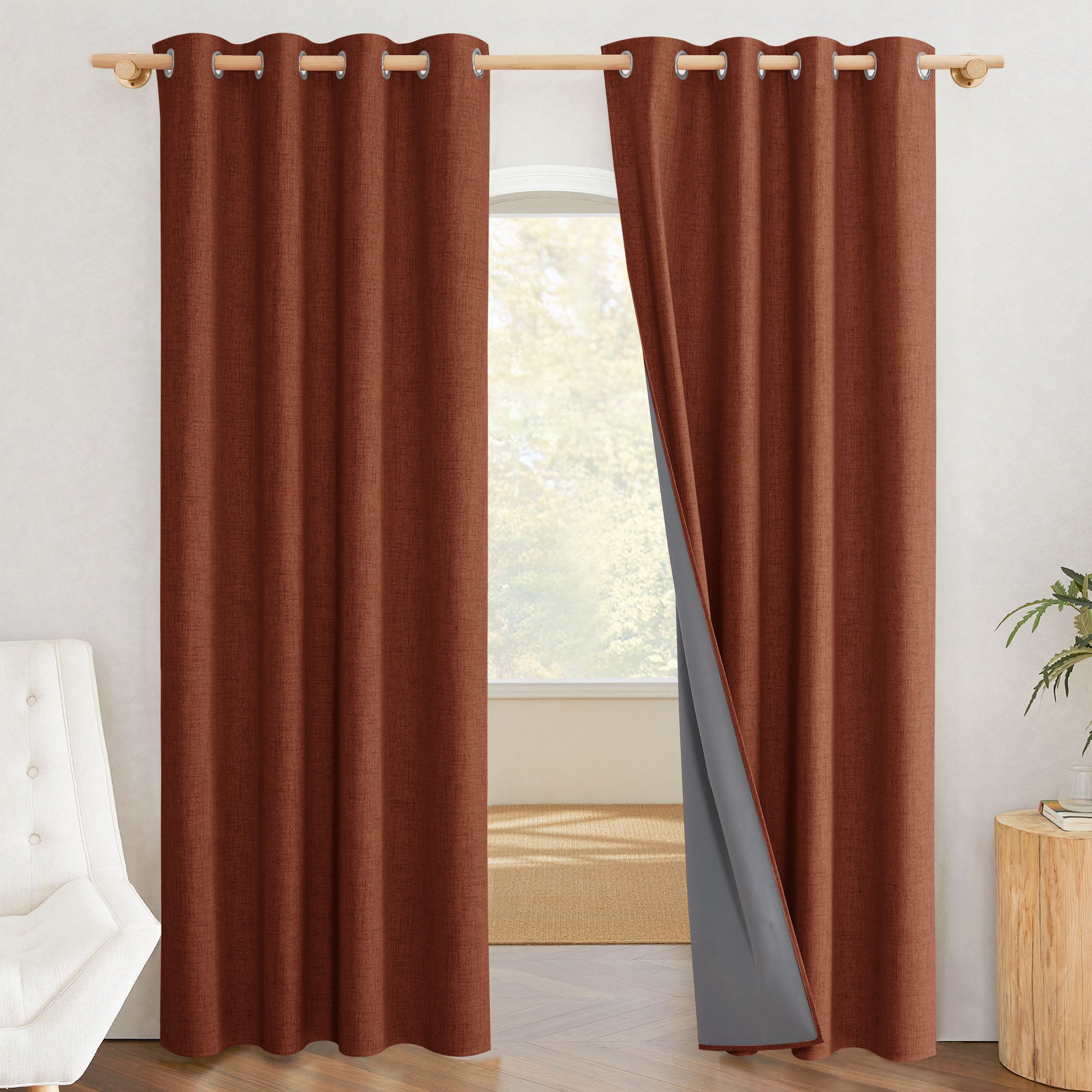 A pair of rust-colored 100% blackout linen curtains, with one panel pulled back to show the gray thermal liner.