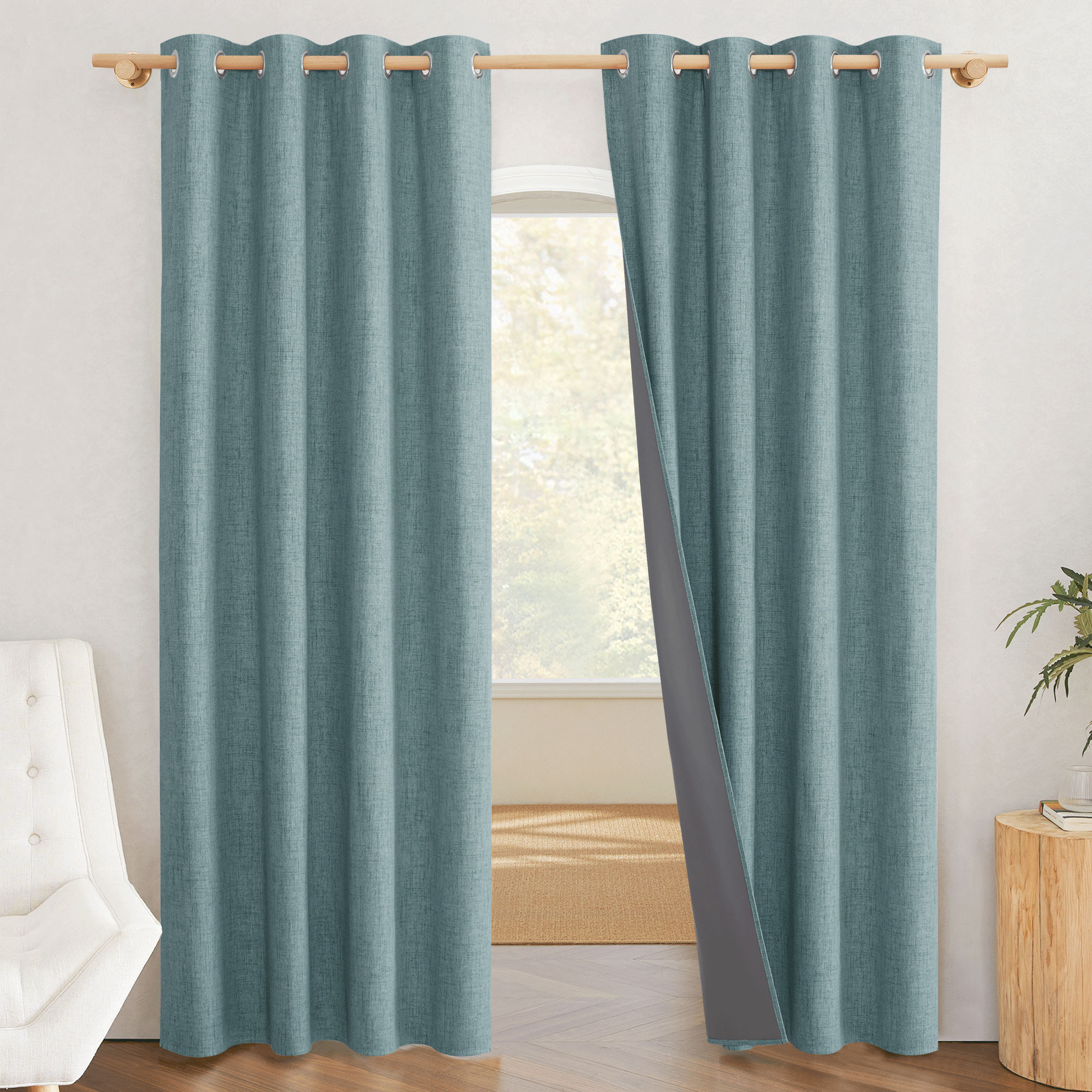 Teal linen-textured blackout curtain panel pulled aside to display the thick, gray light-blocking liner inside.
