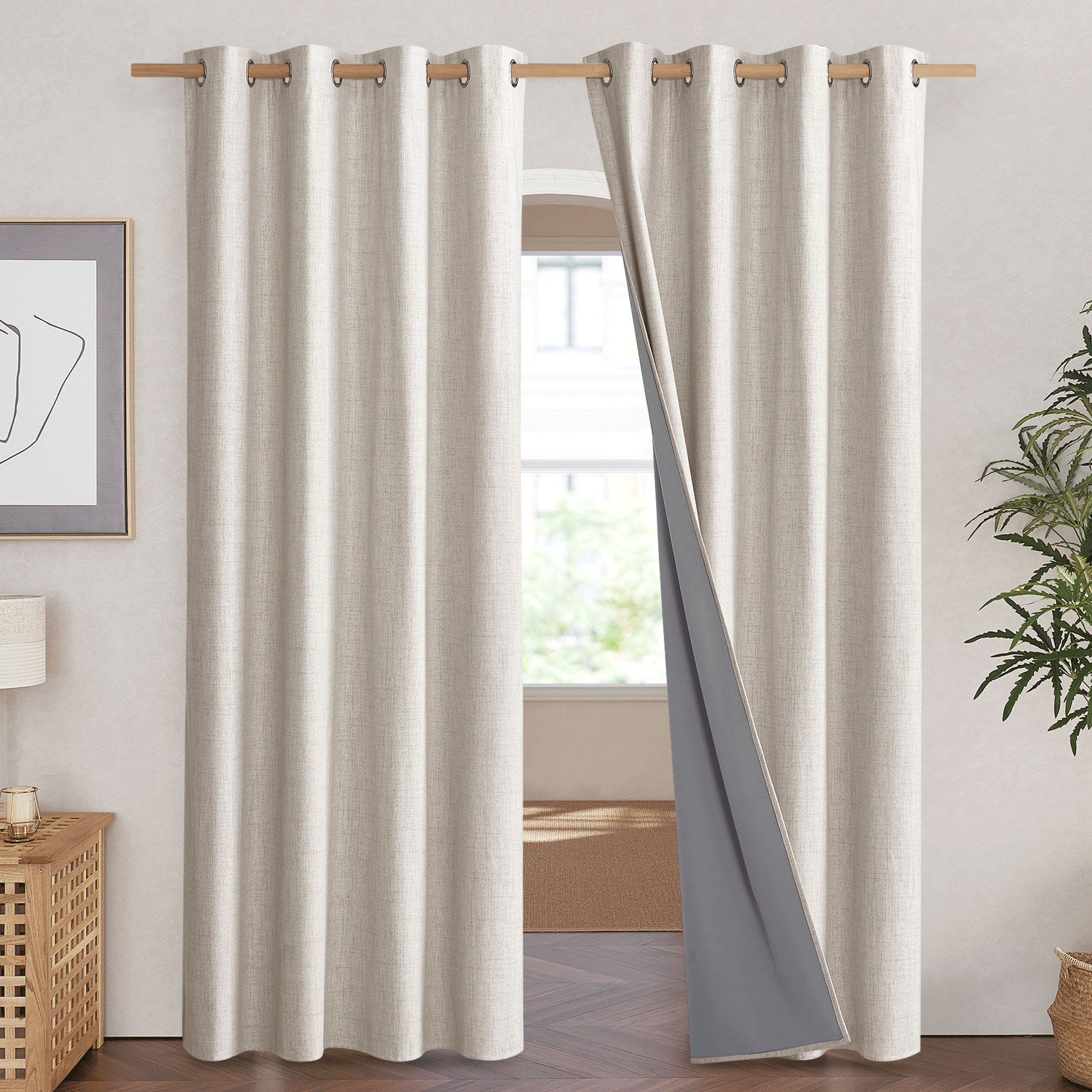 A natural linen blackout curtain pulled aside to reveal the thick, grey 100% blackout thermal liner on the back.