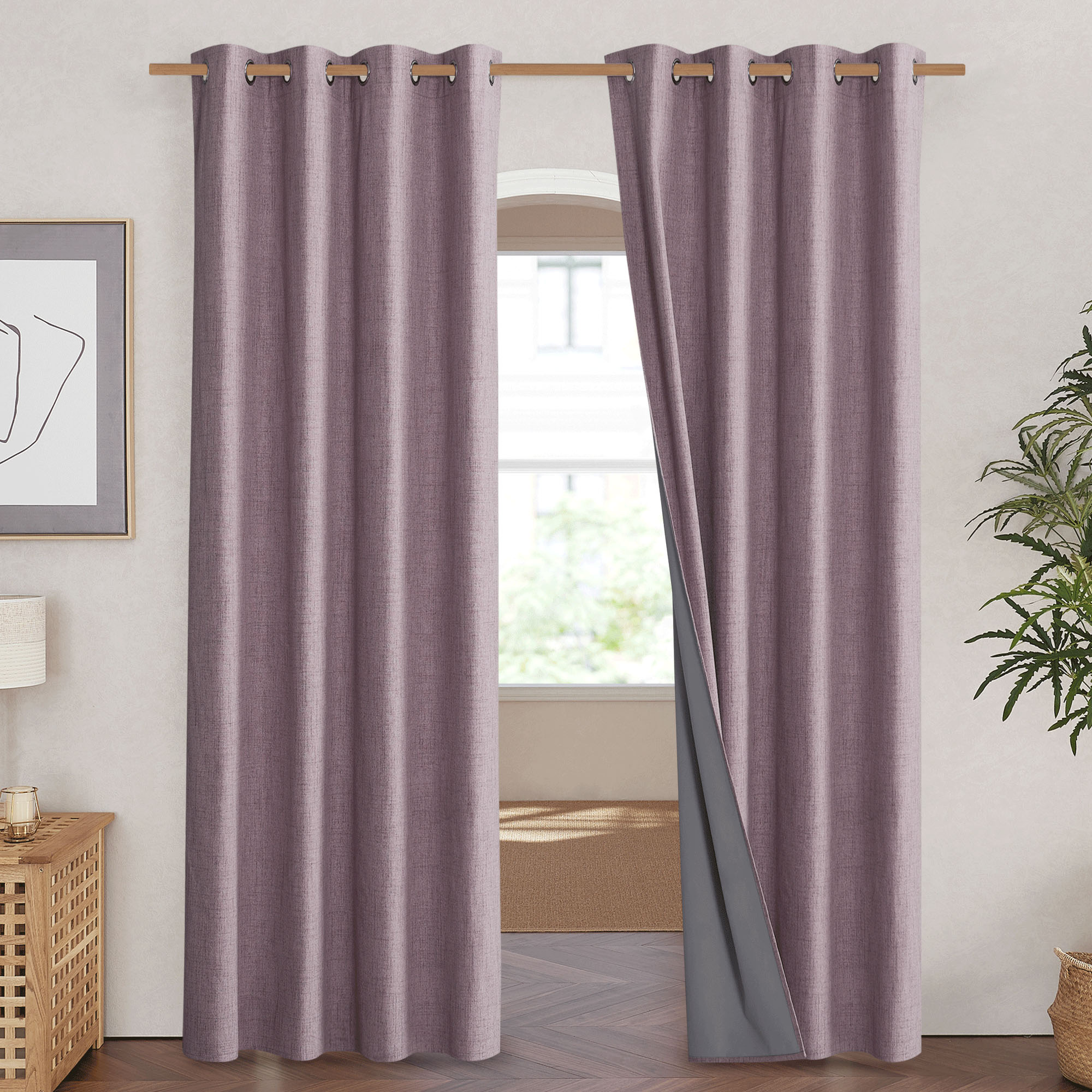 Mauve-purple linen blackout curtains hung on a rod, with one panel pulled back to show the gray 100% blackout liner.