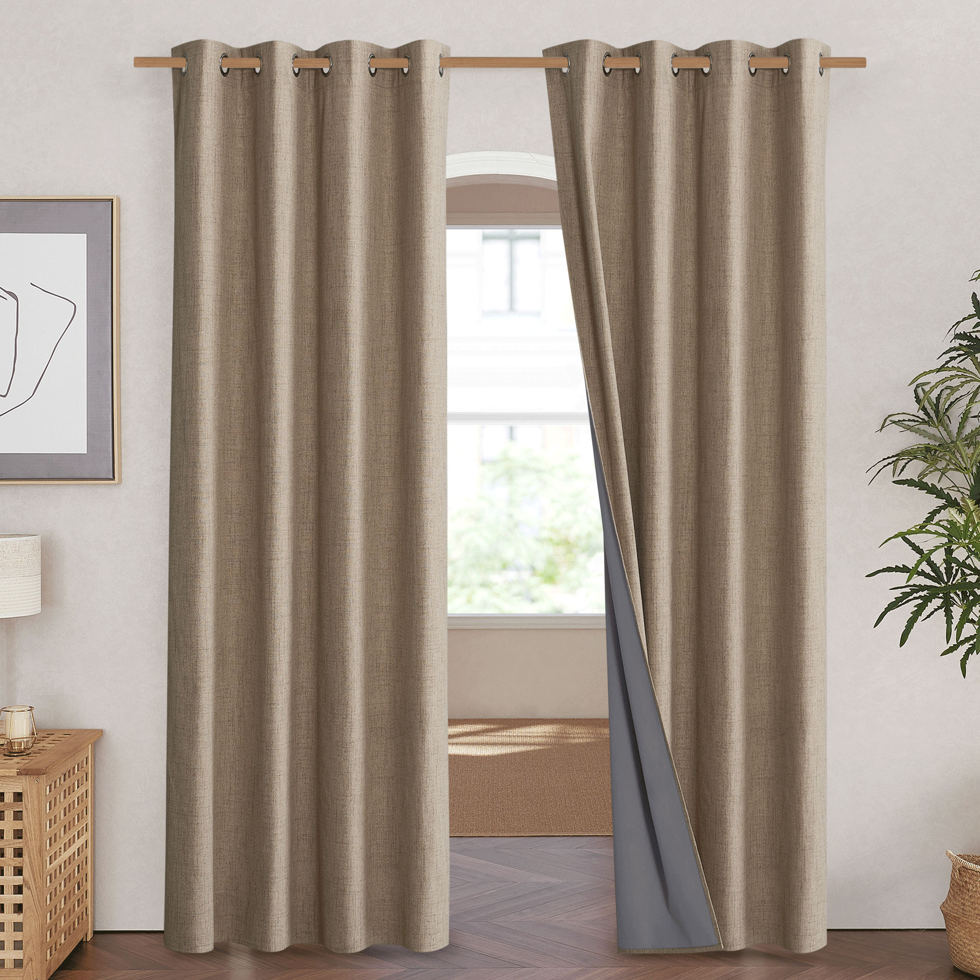 Beige linen blackout curtains hanging on a rod, with one panel pulled back to reveal the dark grey 100% blackout liner.