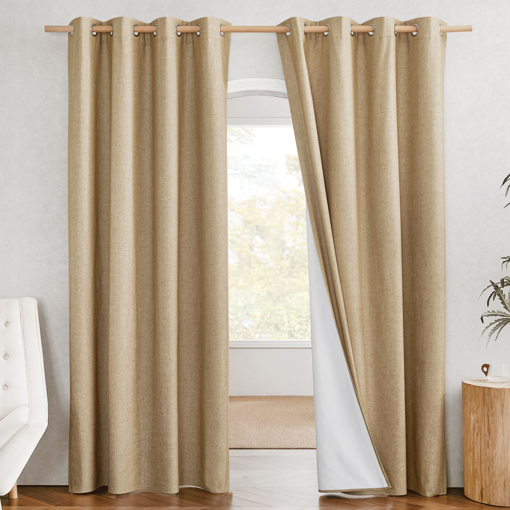 A pair of tan linen grommet curtains, with the right panel pulled aside to reveal the white 100% blackout lining.