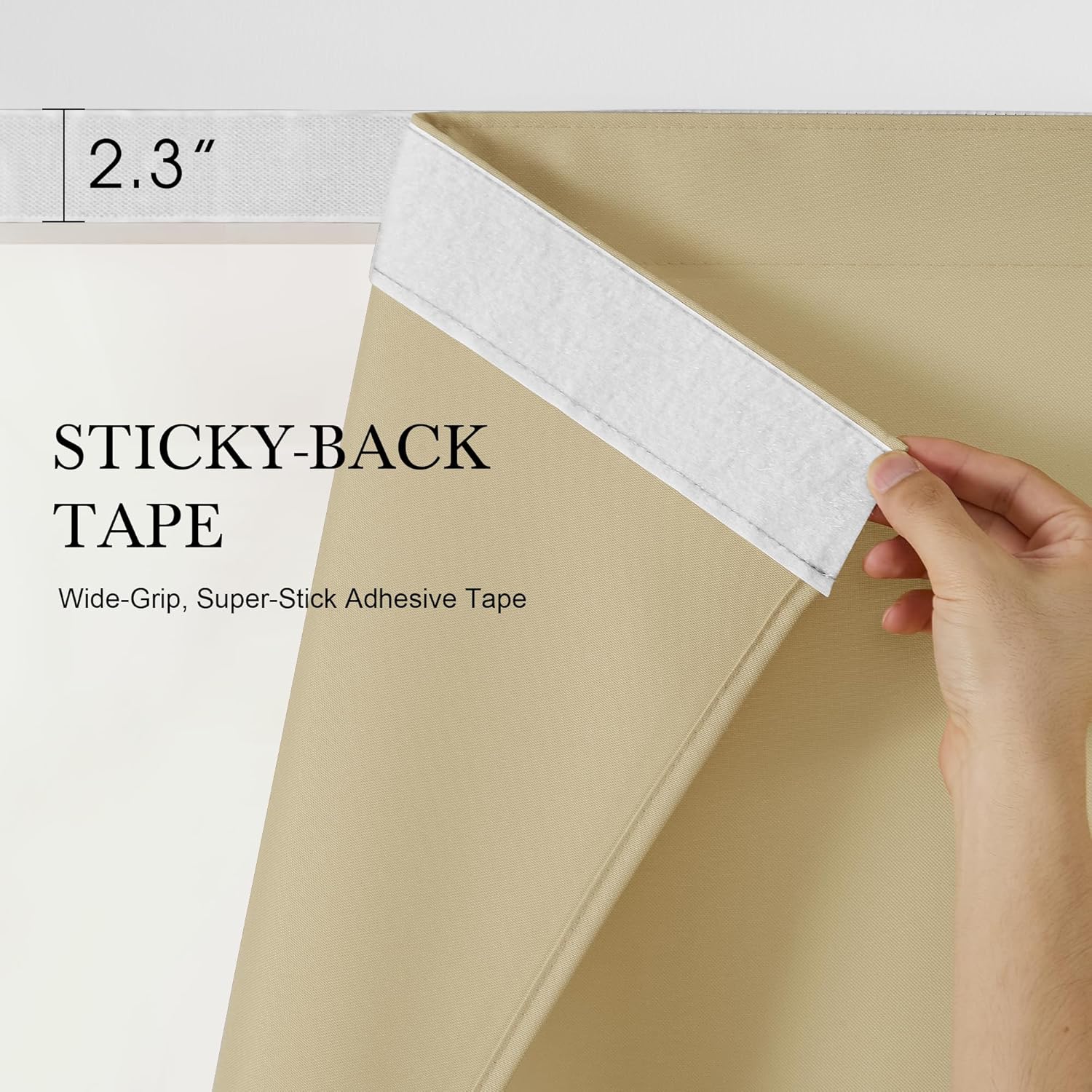 Close-up of hand peeling 2.3-inch white super-stick adhesive tape from a beige blackout fabric