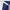Close-up of a hand peeling a 2.3-inch wide, white, super-stick adhesive tape from royal blue textured fabric.