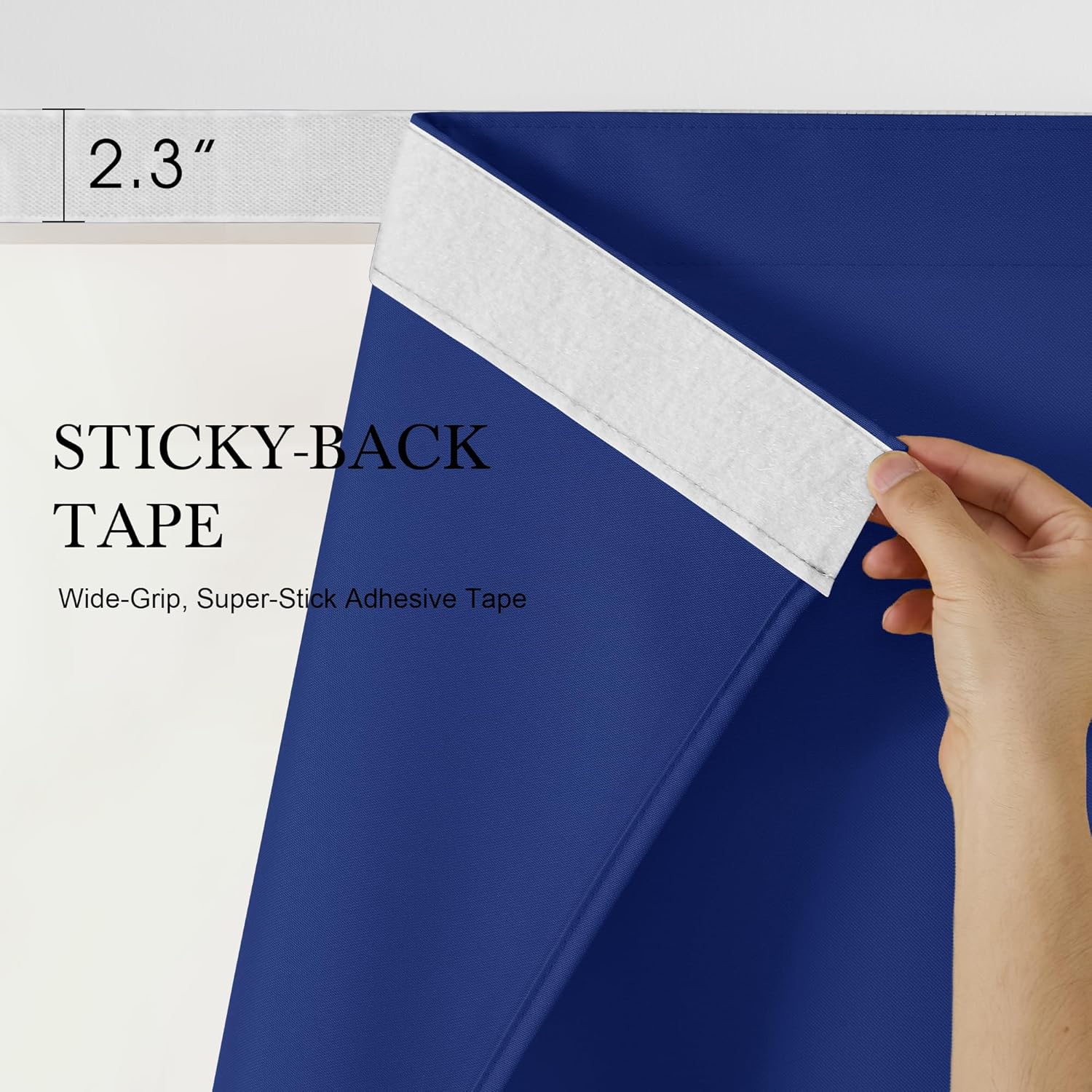 Close-up of a hand peeling a 2.3-inch wide, white, super-stick adhesive tape from royal blue textured fabric.