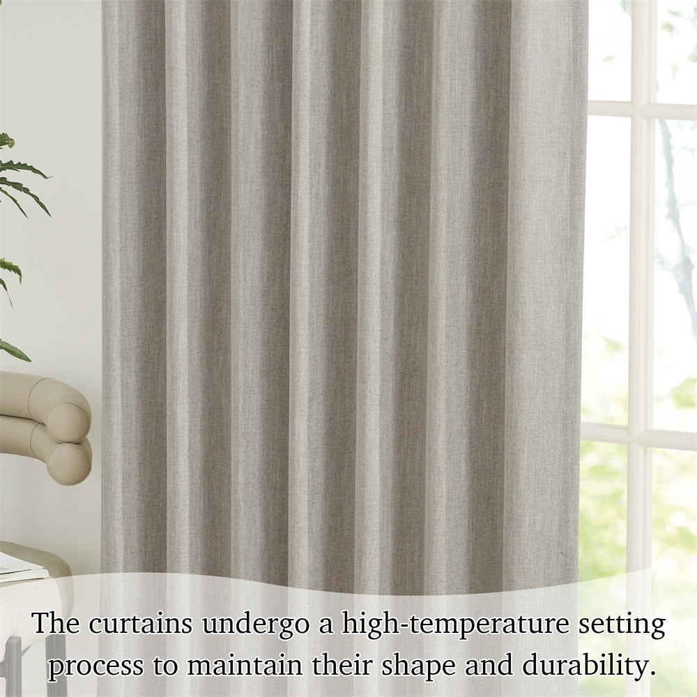 Close-up of grey faux linen pinch pleat blackout curtain, showing its subtle texture and neat vertical folds next to a window.