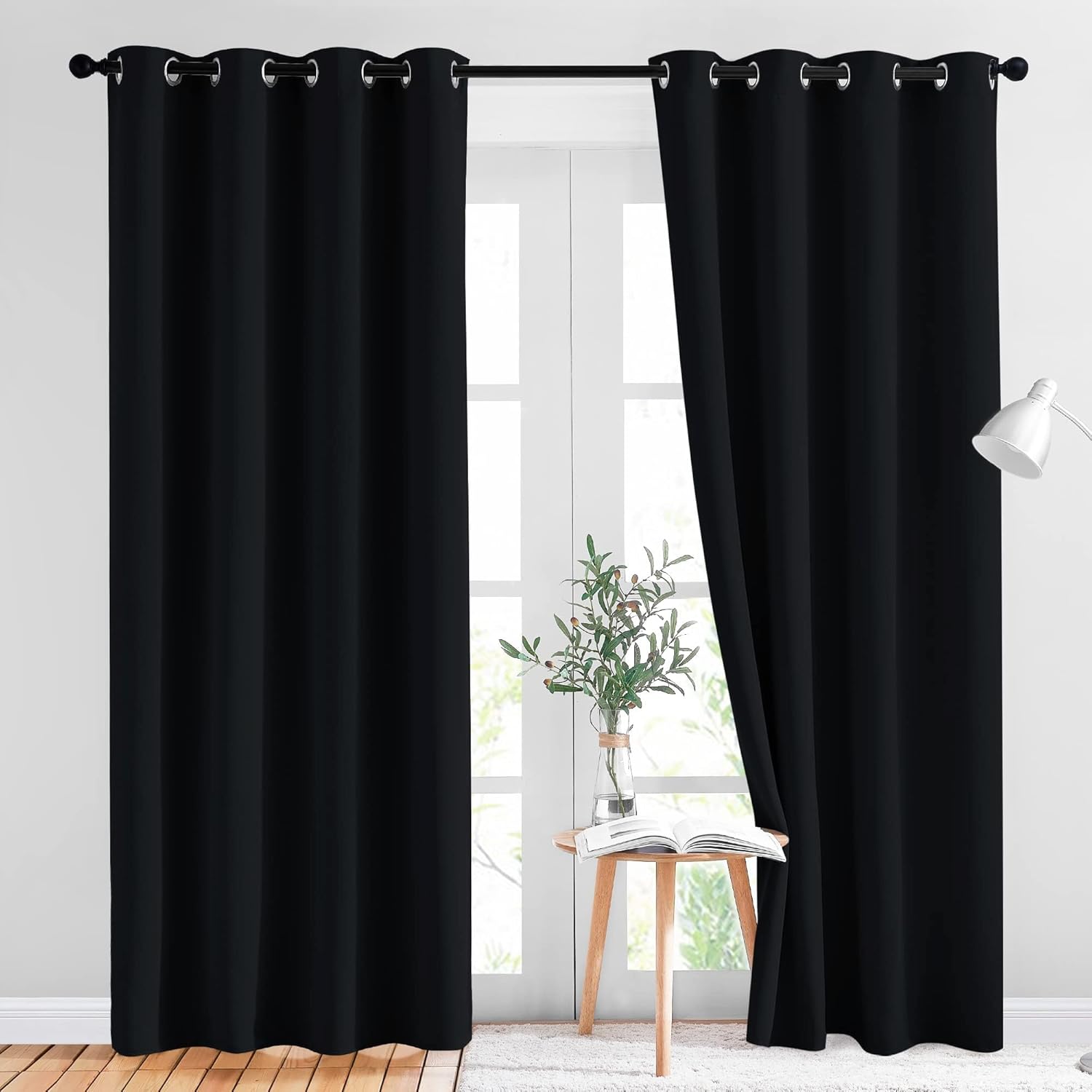 NICETOWN black blackout curtains (2-piece set) for a bedroom, one fully closed for privacy, the other partially open.