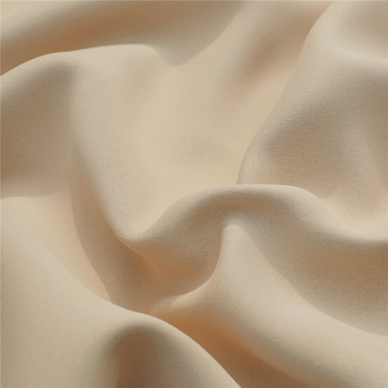 Close-up of light beige waterproof custom outdoor curtain fabric, highlighting its durable texture and soft, flowing folds.