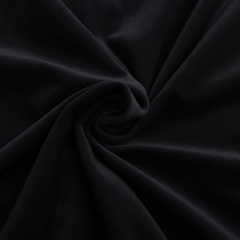 Deep black velvet fabric showcasing its luxurious soft texture and subtle sheen with graceful folds.