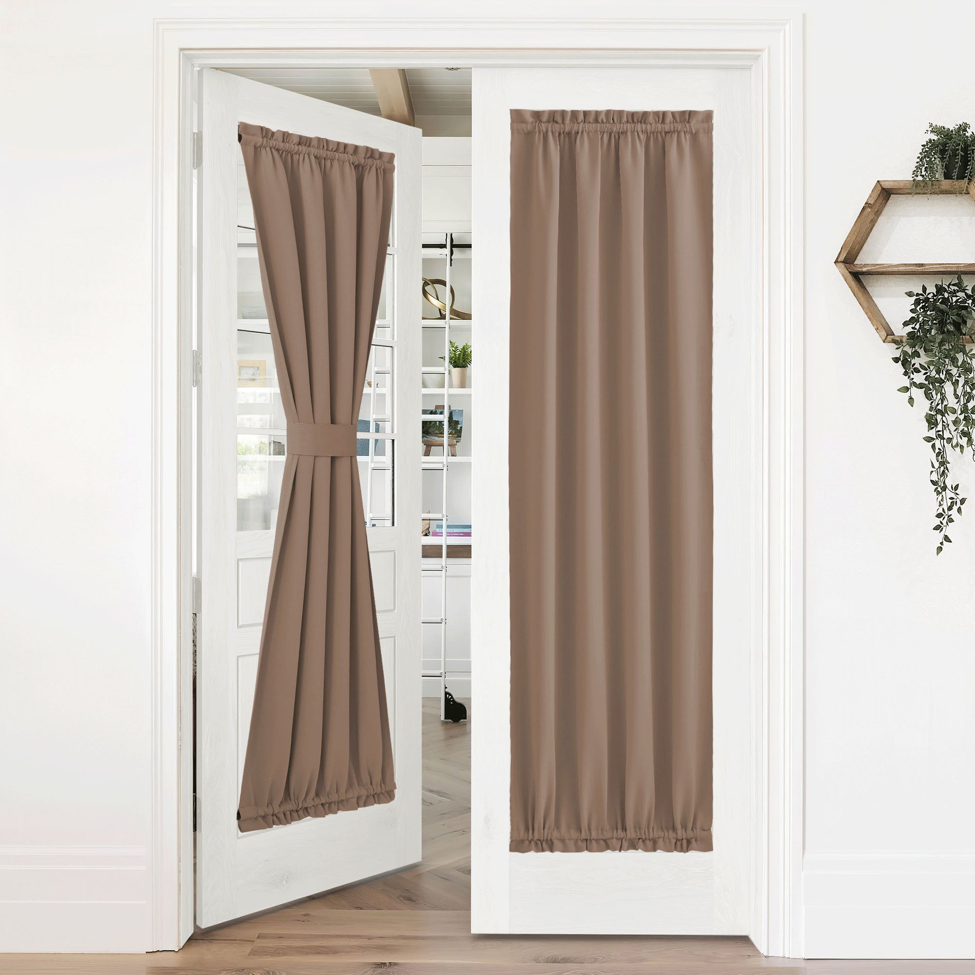 Brown 50% blackout privacy door curtains on white French doors. One curtain tied back, the other fully down.