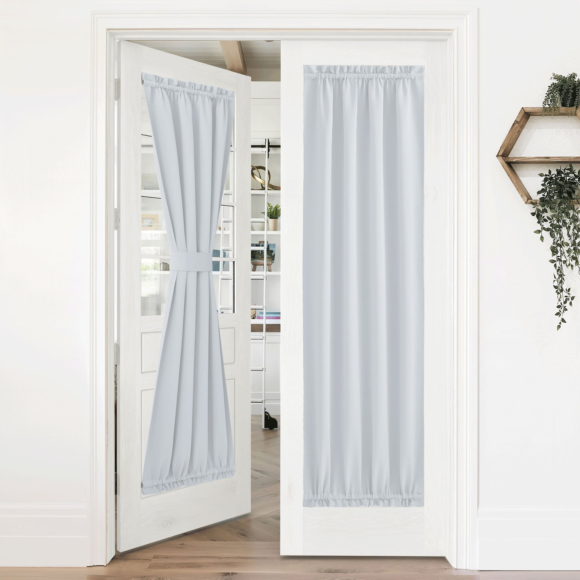 Light gray 50% blackout privacy door curtains on white French doors. One curtain is tied back, the other fully extended.