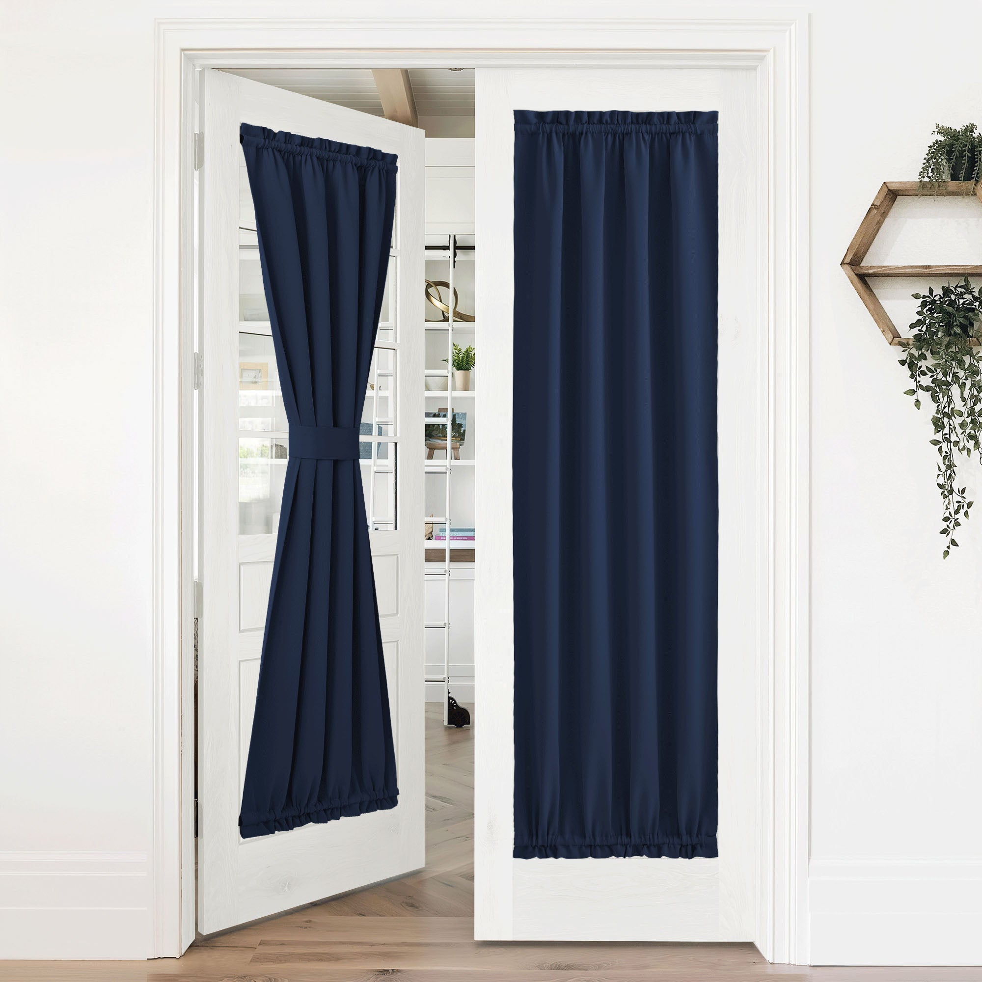 Navy blue 50% blackout privacy door curtains on white french doors, one tied back, the other fully closed.