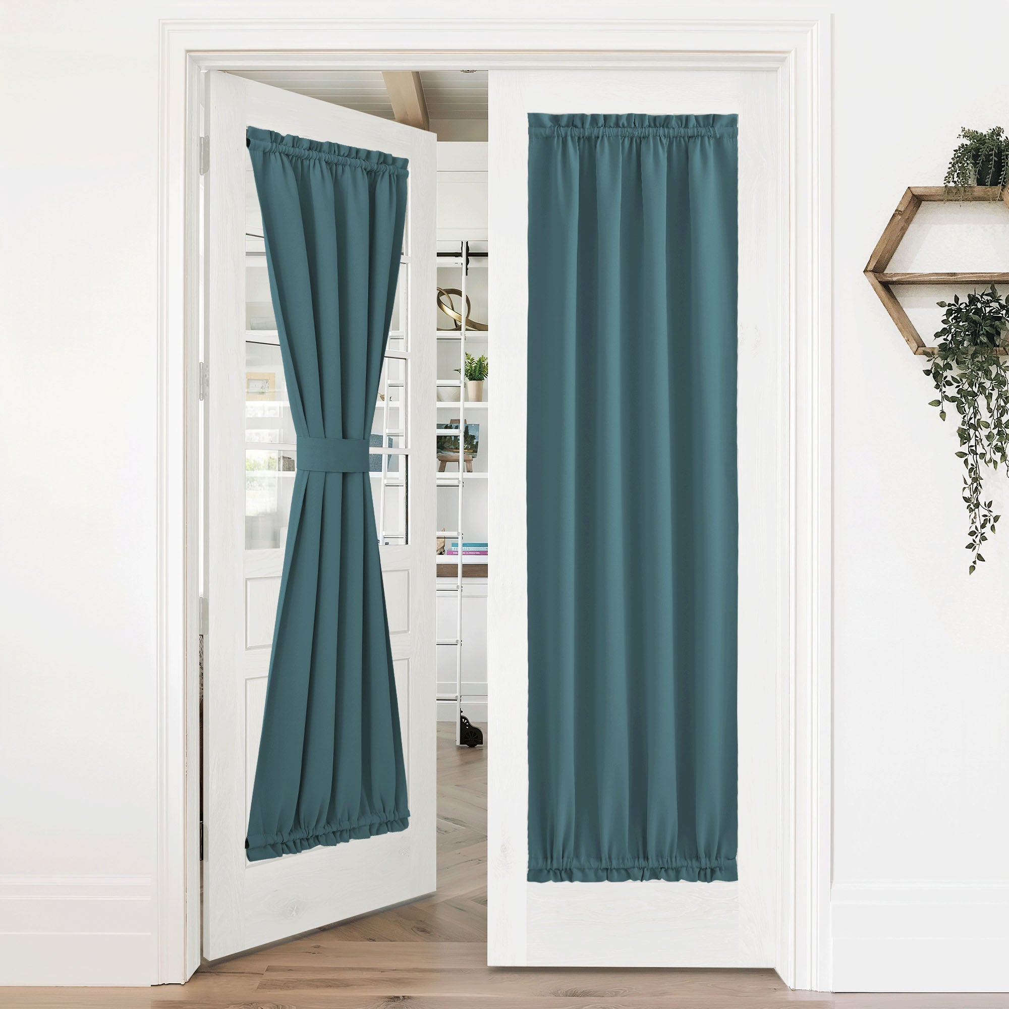 Teal 50% blackout privacy door curtains on white french doors. One curtain tied back, the other fully closed, both with rod pockets.