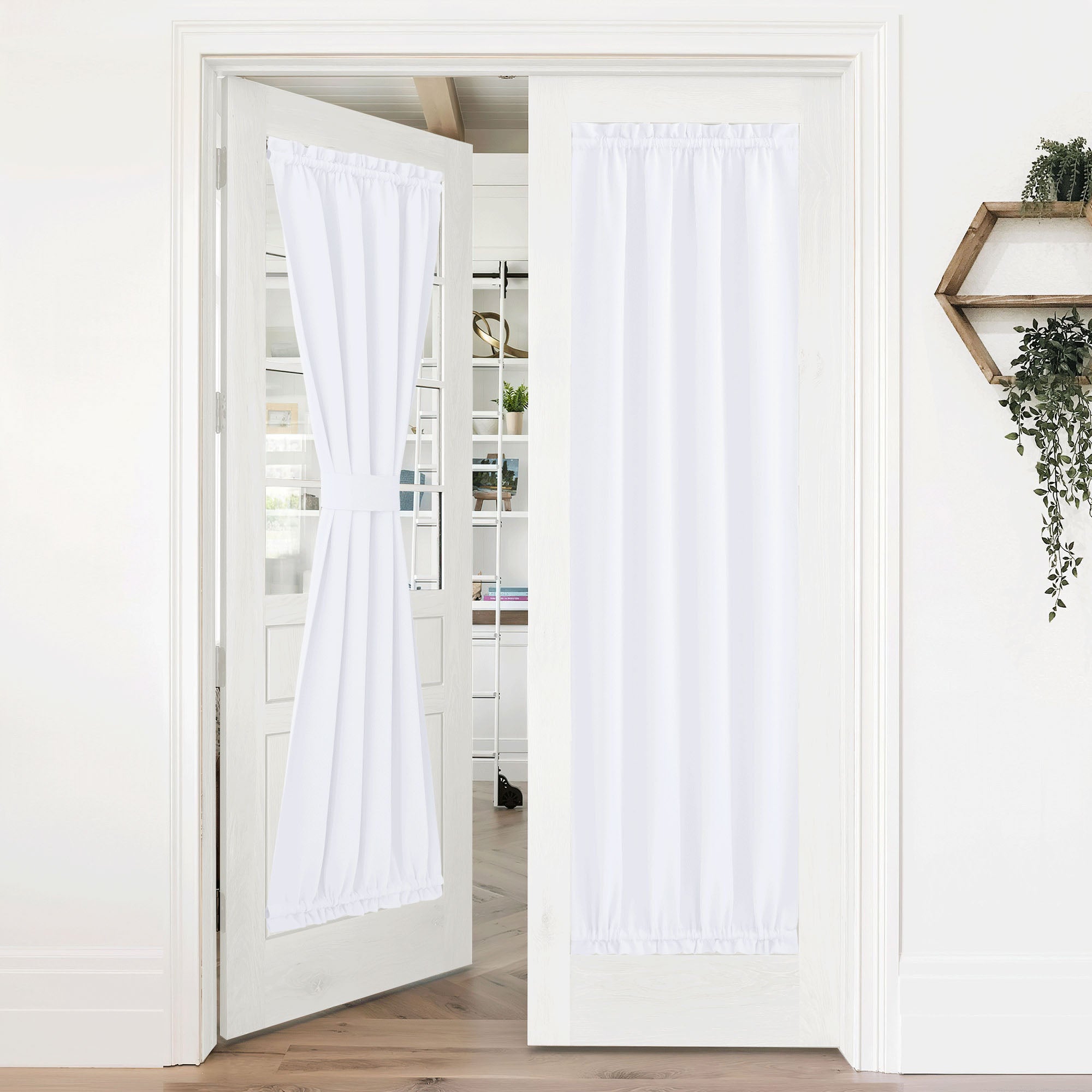 White 50% blackout privacy door curtains on French doors; one tied back to show versatility, the other closed for light control.