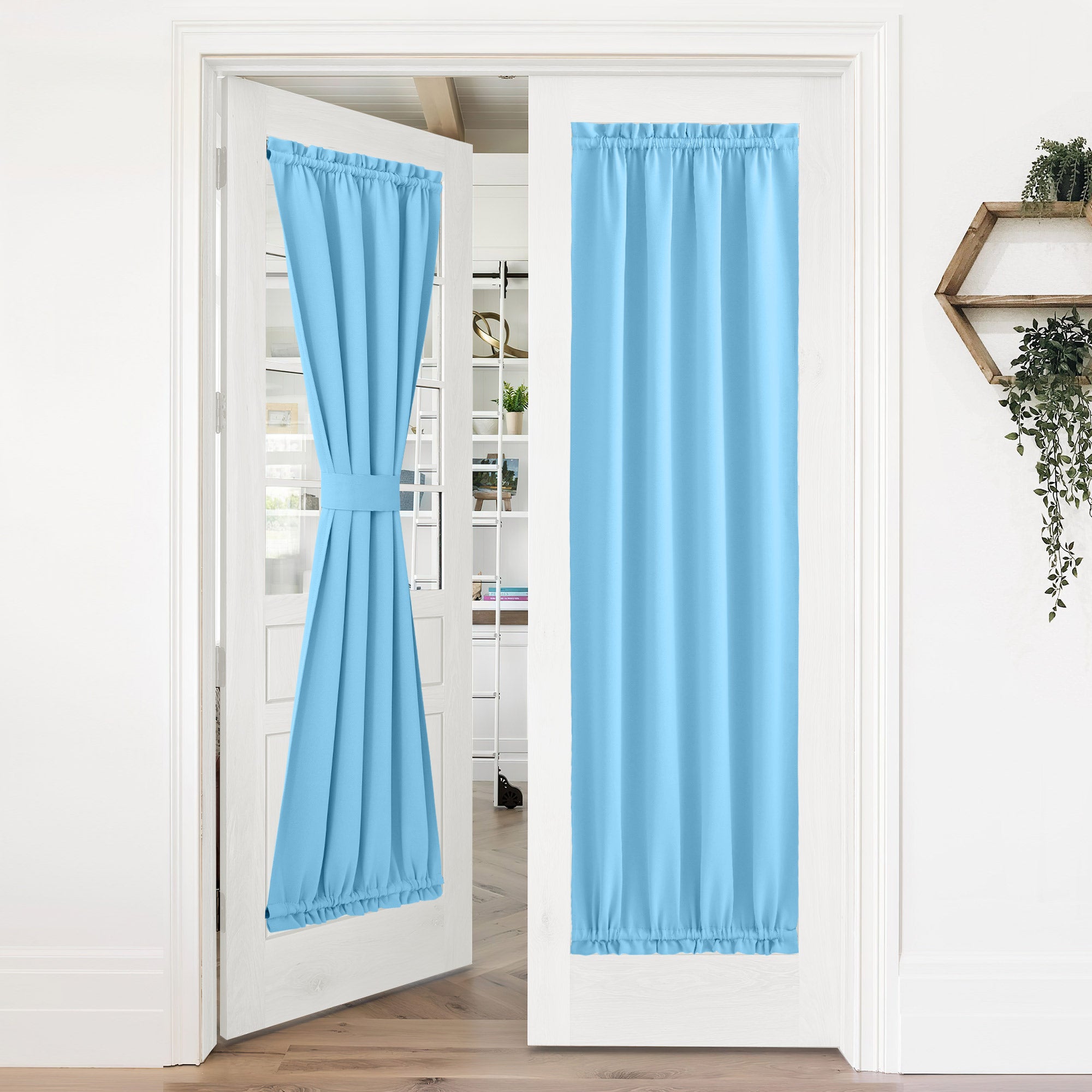 Light blue door curtains on a double glass door; one tied back, one fully extended for 50% blackout privacy.