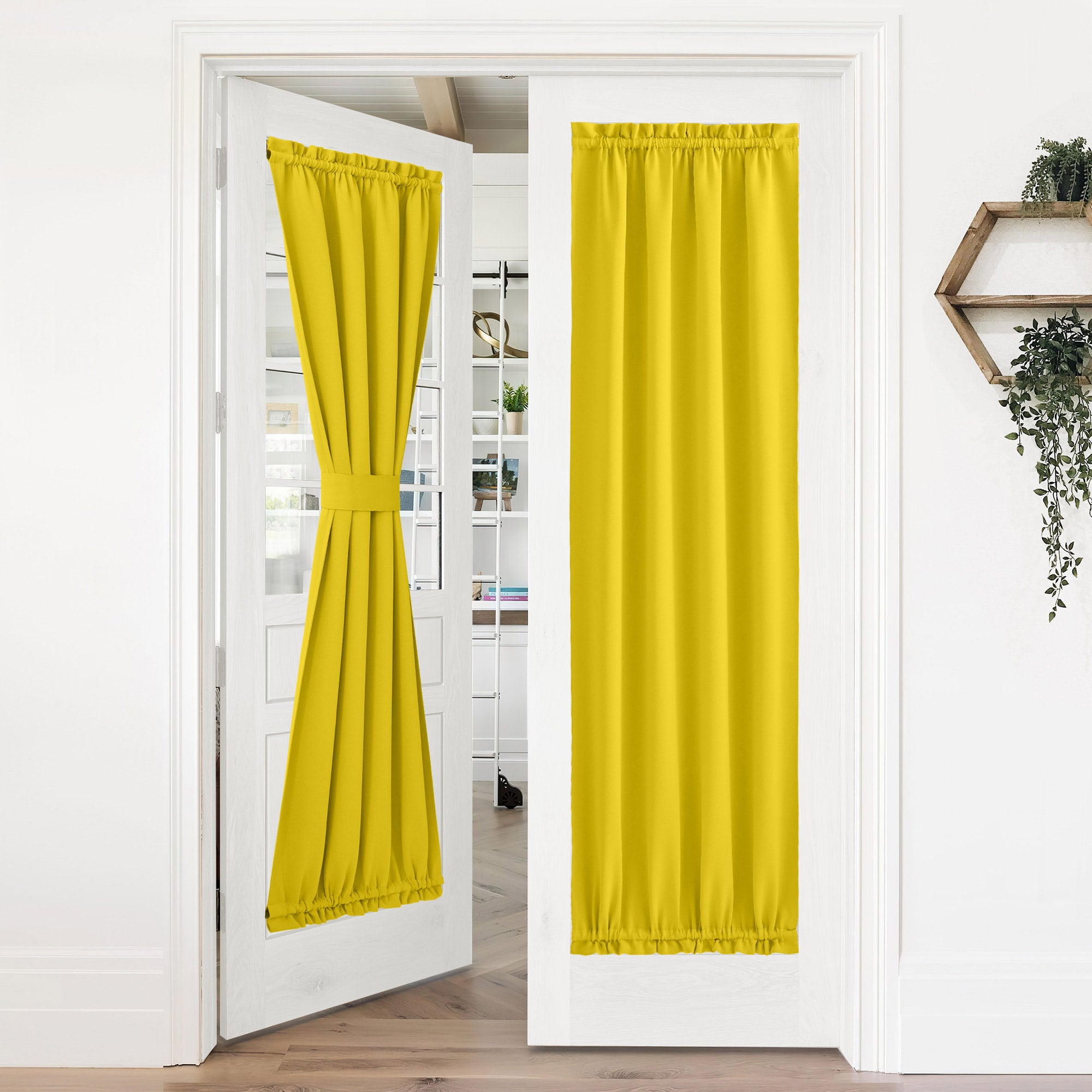 Yellow 50% blackout privacy door curtains on French doors. One panel tied back, the other fully down for complete privacy.