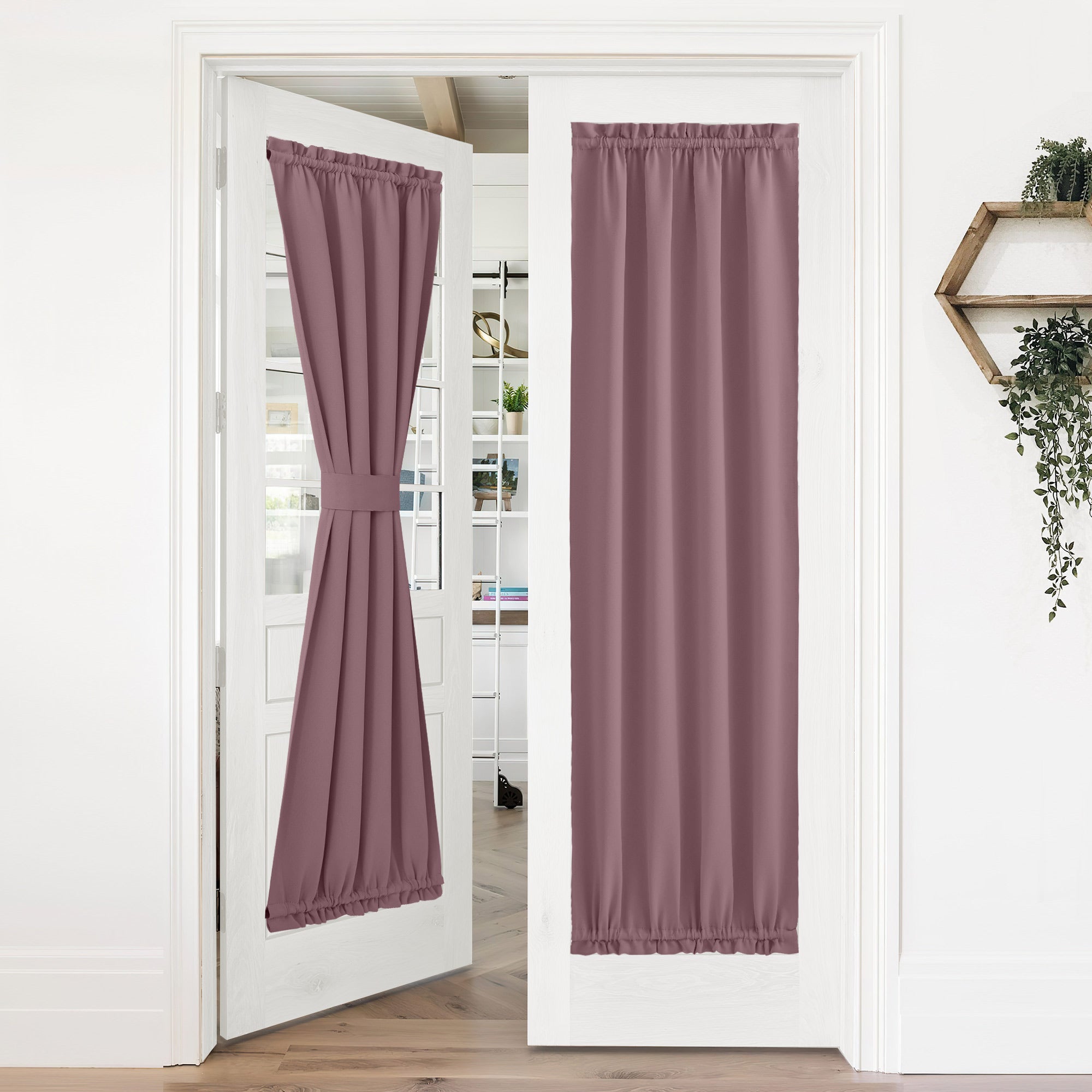 Two dusty rose 50% blackout privacy door curtains installed on white glass french doors. One curtain is tied back.