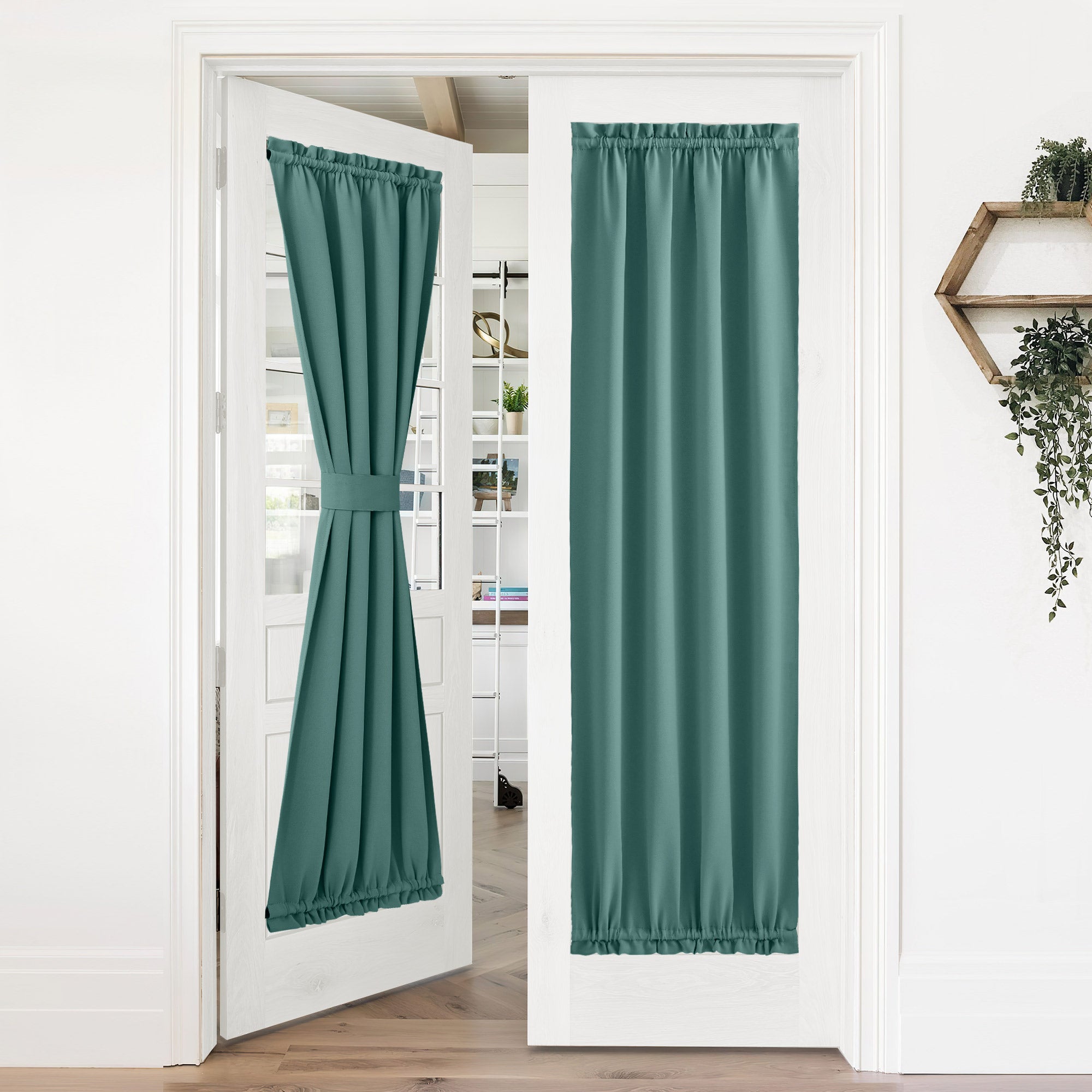 Teal 50% blackout privacy door curtains on white French doors. One tied back, the other fully extended for room darkening.