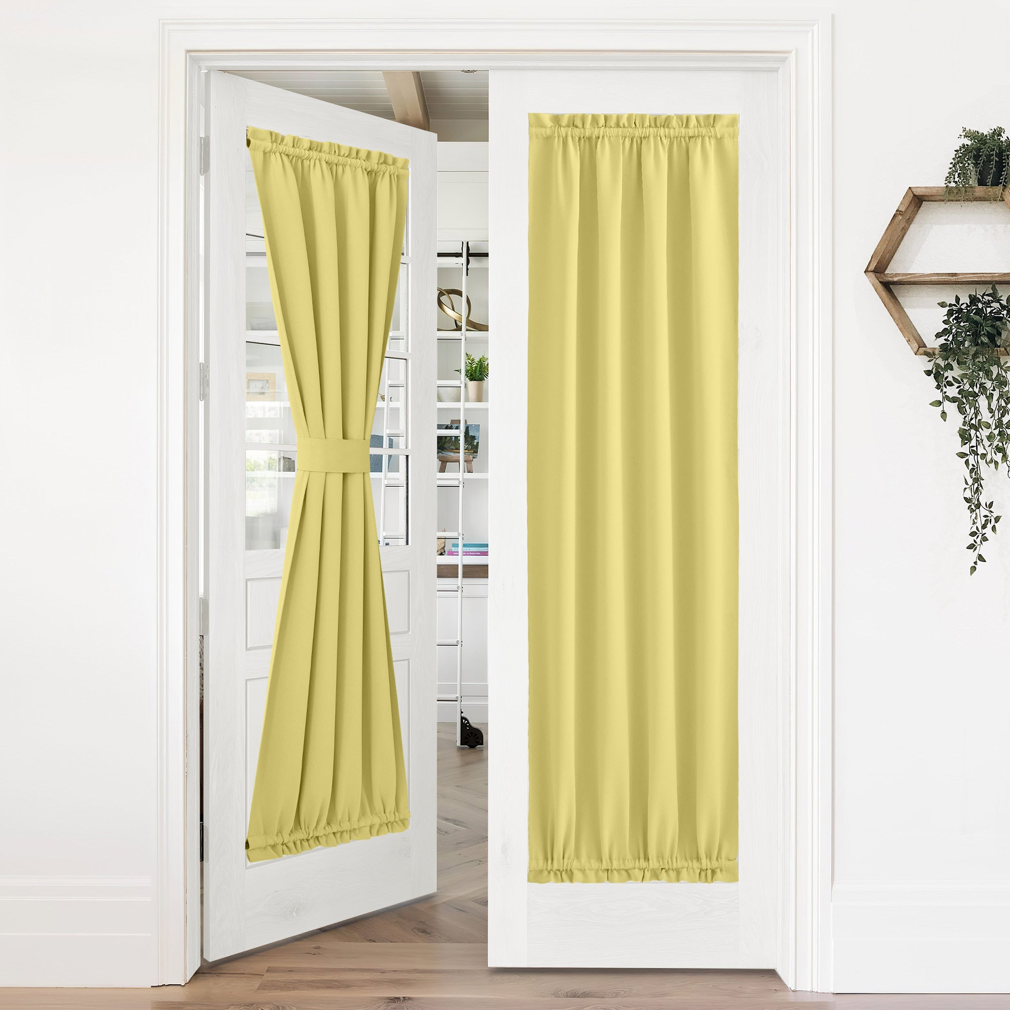 Yellow 50% blackout privacy door curtains on white French doors; one tied back, the other hanging straight.