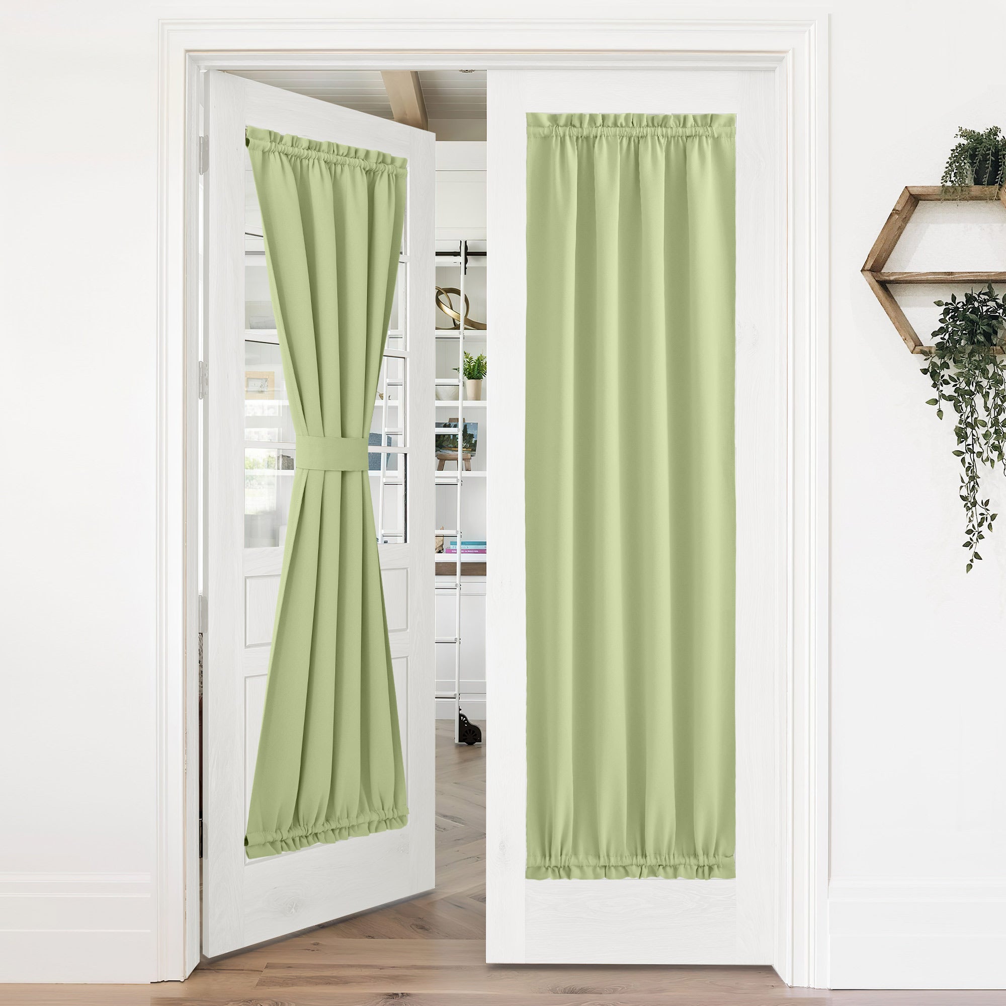 Pair of light green 50% blackout privacy door curtains on French doors; one neatly tied back, the other fully drawn.