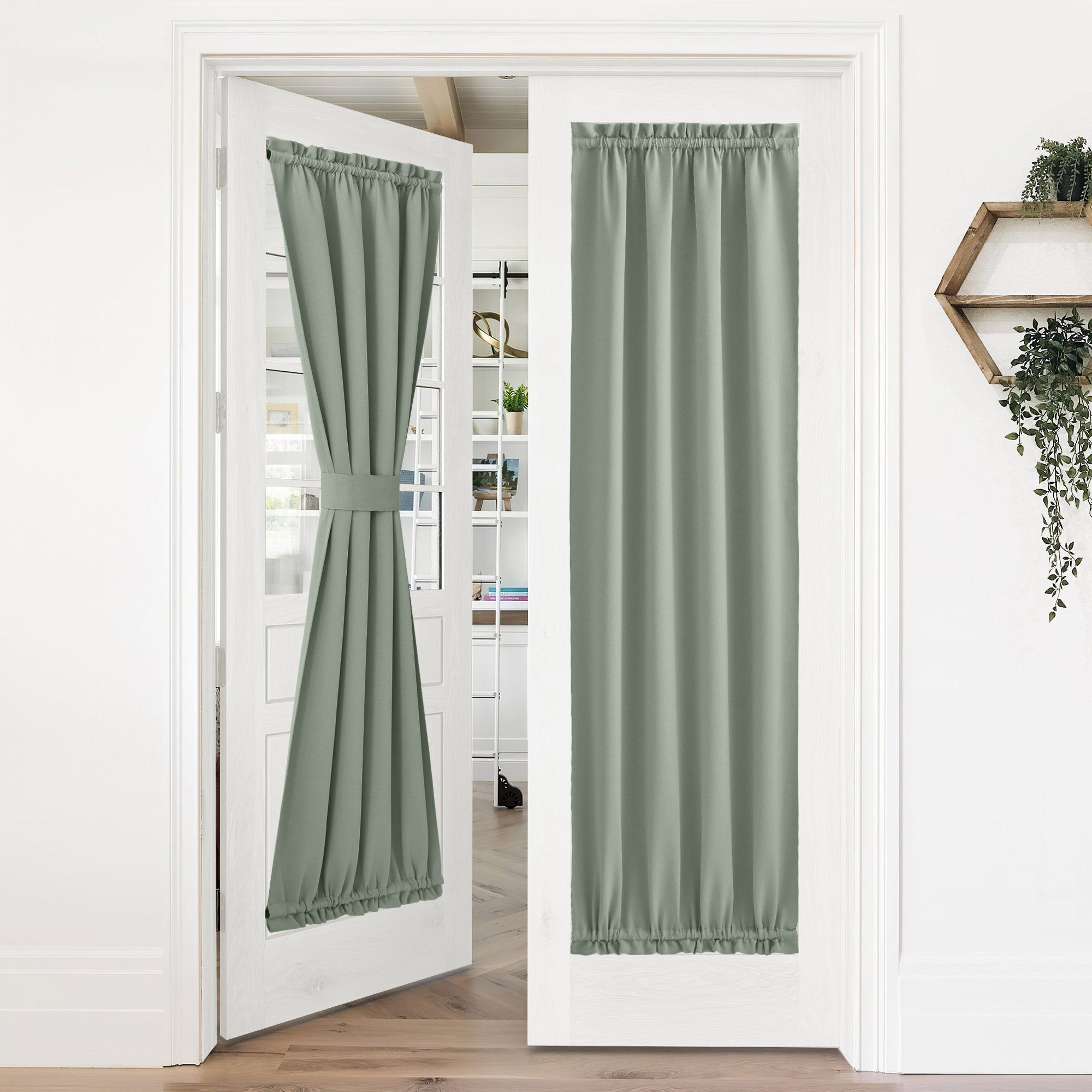 Sage green blackout privacy door curtains on French glass doors. One panel tied back, the other fully extended for privacy.