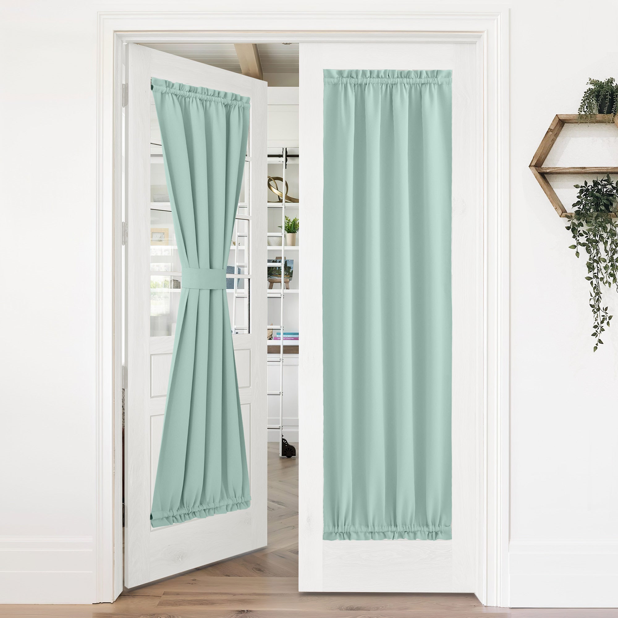 Mint green 50% blackout privacy door curtains on white French doors; one tied back, one fully extended for privacy.
