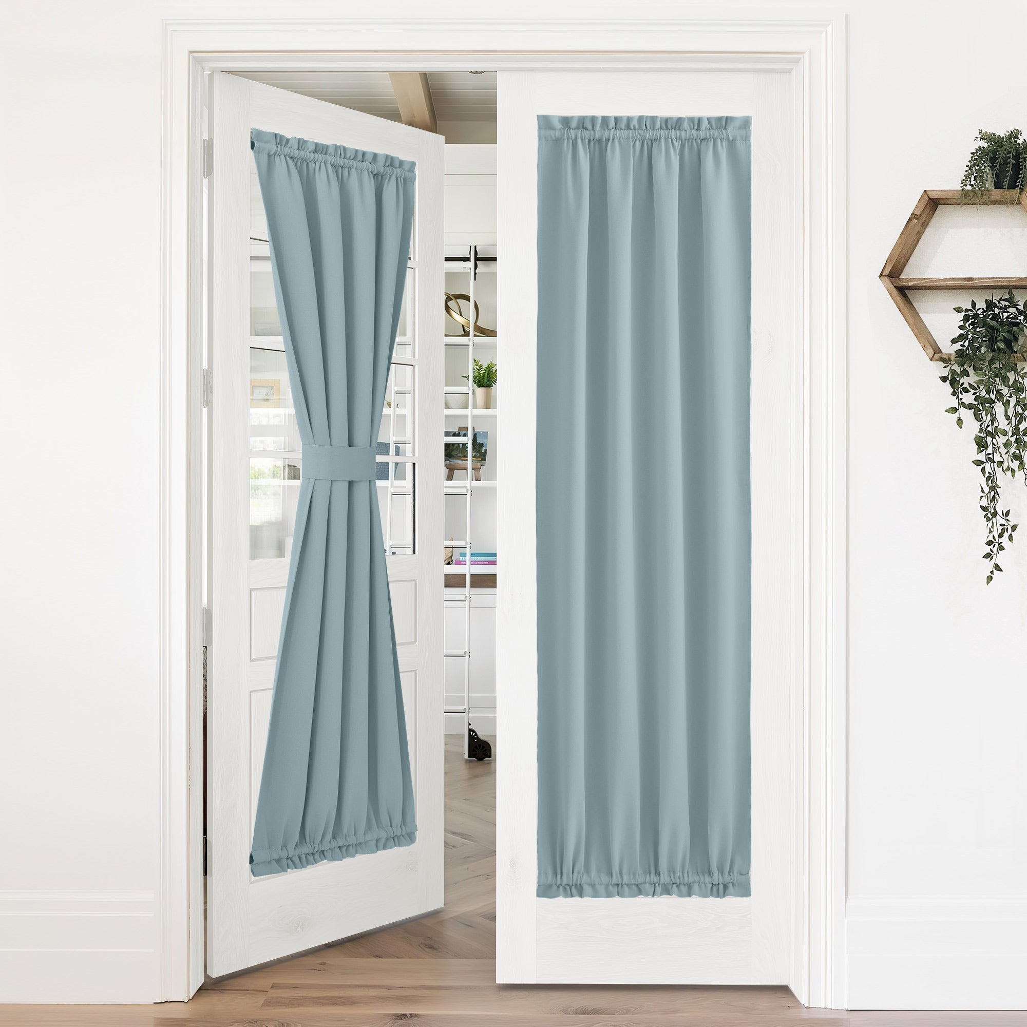 Light blue 50% blackout privacy door curtains on white French doors; one tied back, the other providing full coverage.