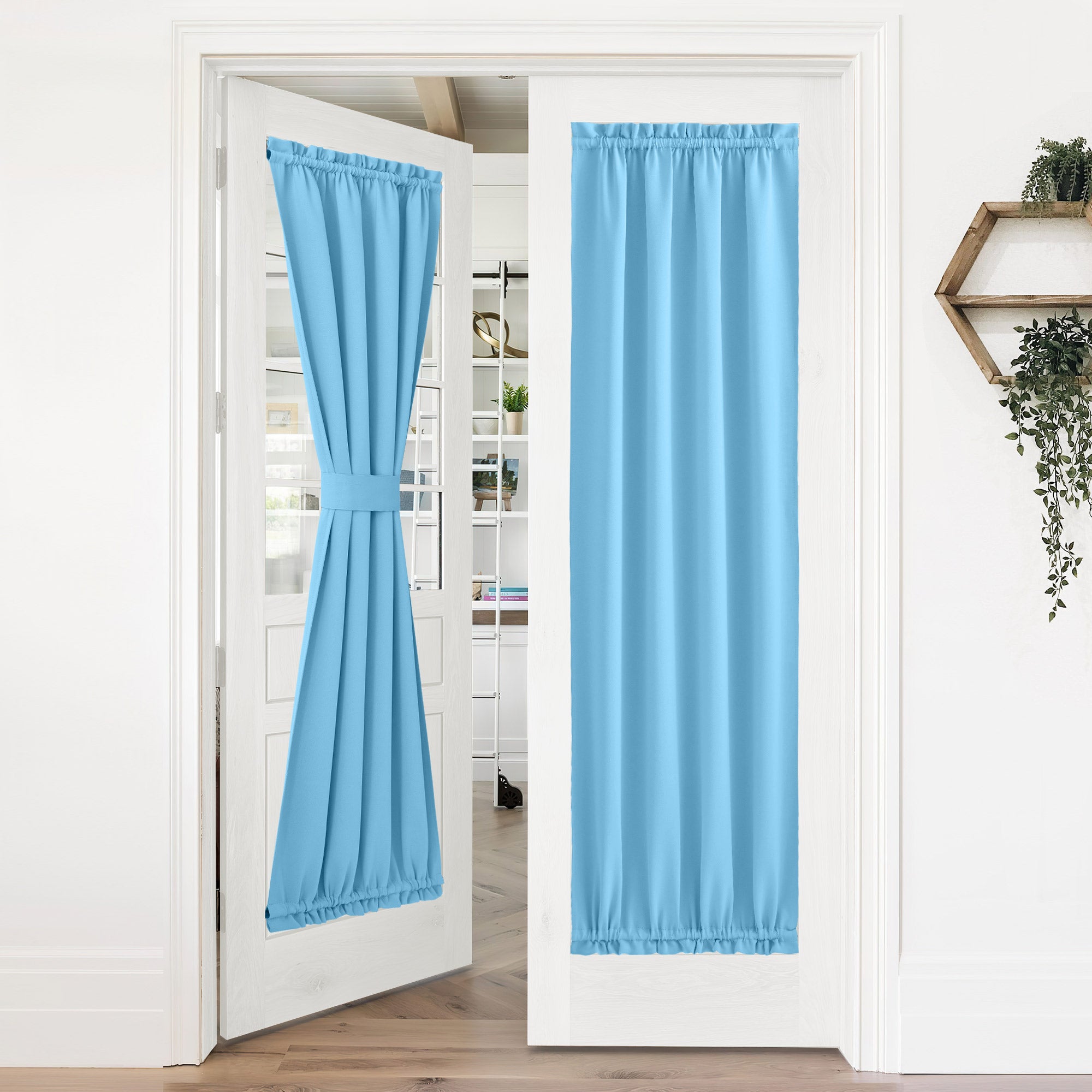 Light blue 50% blackout privacy door curtains on white French doors; one tied back, one fully closed.