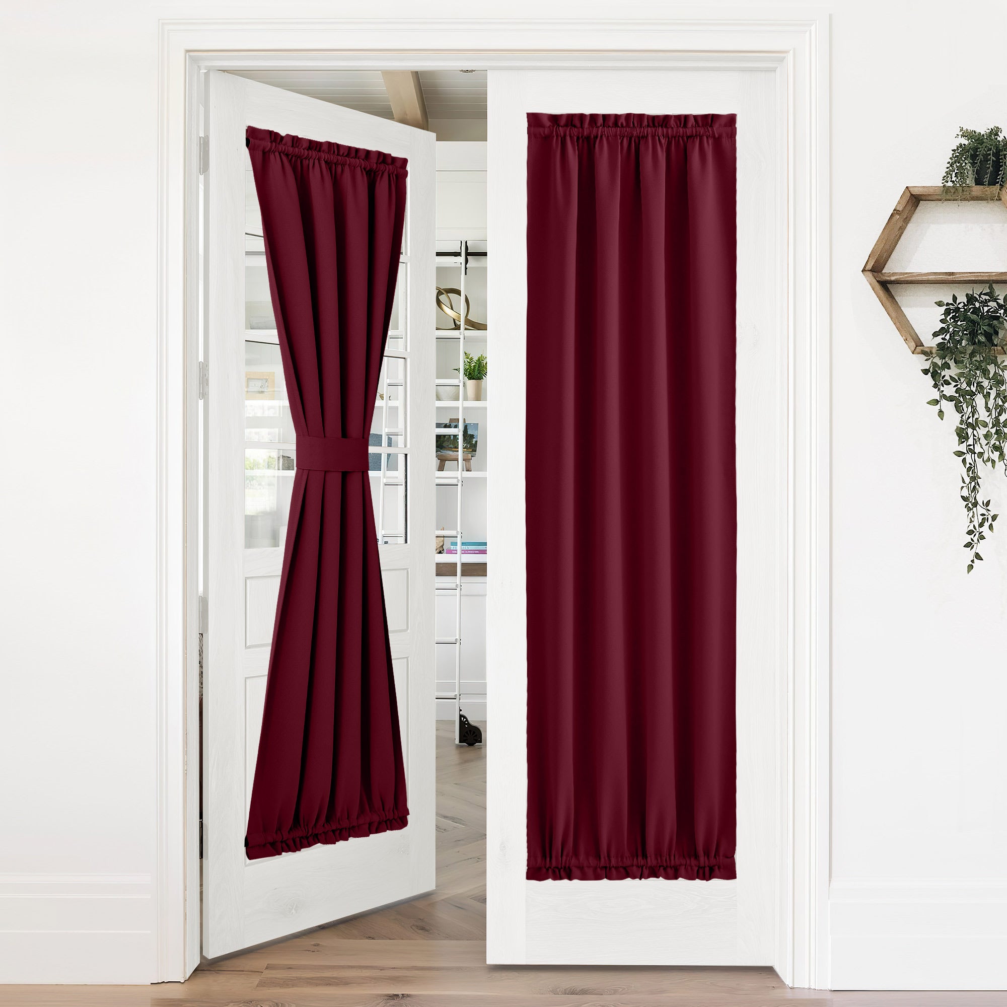 Burgundy 50% blackout privacy door curtains on white French doors. One tie-back, one fully closed, both with rod pockets.