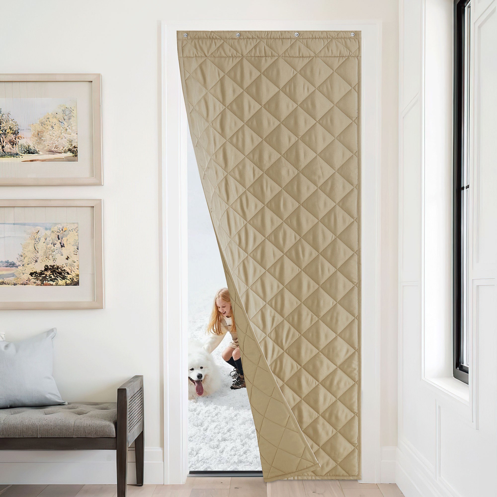 Quilted insulated door curtain keeps home warm as a child and dog play outside in the snow.