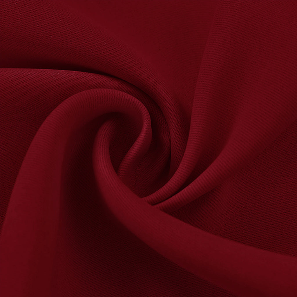 Close-up of a deep red blackout fabric swatch with visible soft texture and elegant folds.