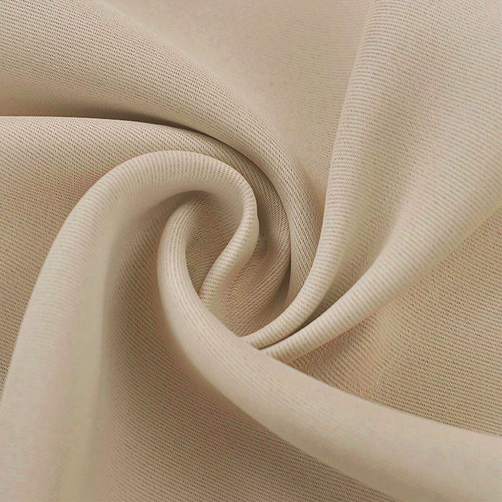 Close-up of a soft, textured beige blackout fabric swatch, showing its thick quality and subtle diagonal weave.