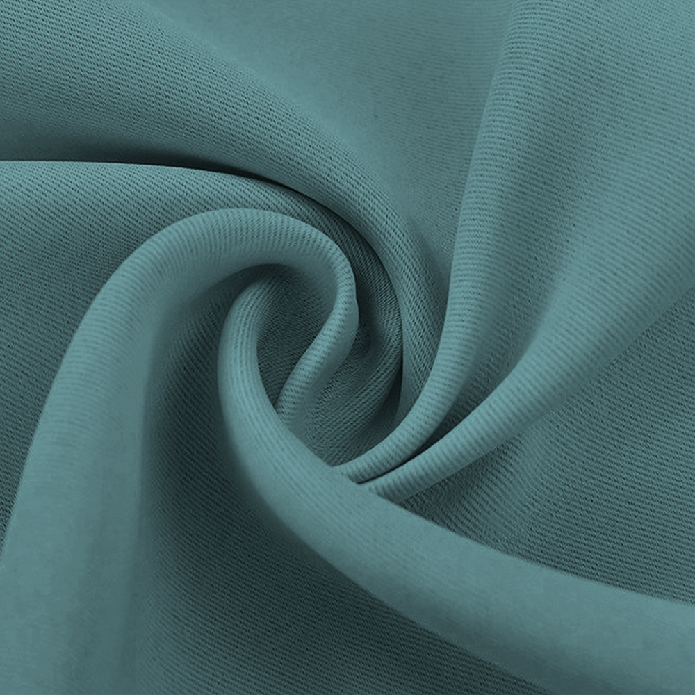 Close-up of a dark teal blackout fabric swatch, showing its soft folds, thick texture, and subtle diagonal weave.