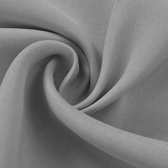 Close-up of a soft gray blackout fabric swatch, revealing its tight weave and smooth texture with gentle folds.