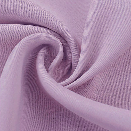 Close-up of folded lilac blackout fabric swatch, highlighting its durable, soft texture for drapes and curtains.