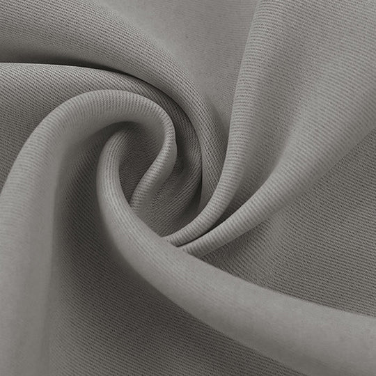 Close-up of a grey blackout fabric swatch, highlighting its textured weave and soft, flowing folds.