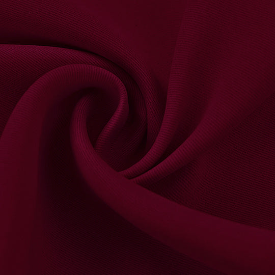 Close-up of a rich maroon blackout fabric swatch, showcasing its smooth yet structured woven texture and soft folds.