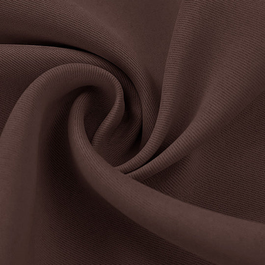 Detailed view of a dark brown blackout fabric swatch, showcasing its soft, subtly ribbed texture and natural folds.