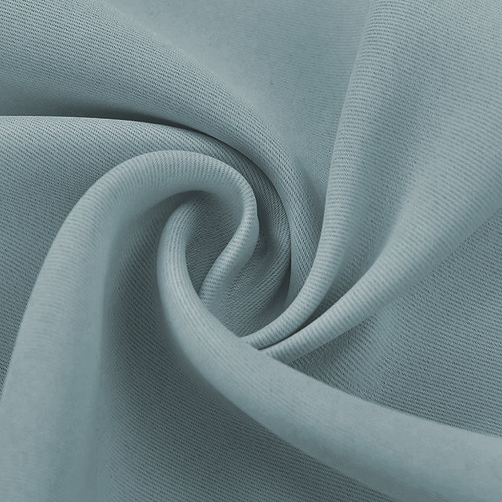 Detailed view of a swirled light blue blackout fabric swatch, highlighting its subtle woven texture and soft, draping quality.