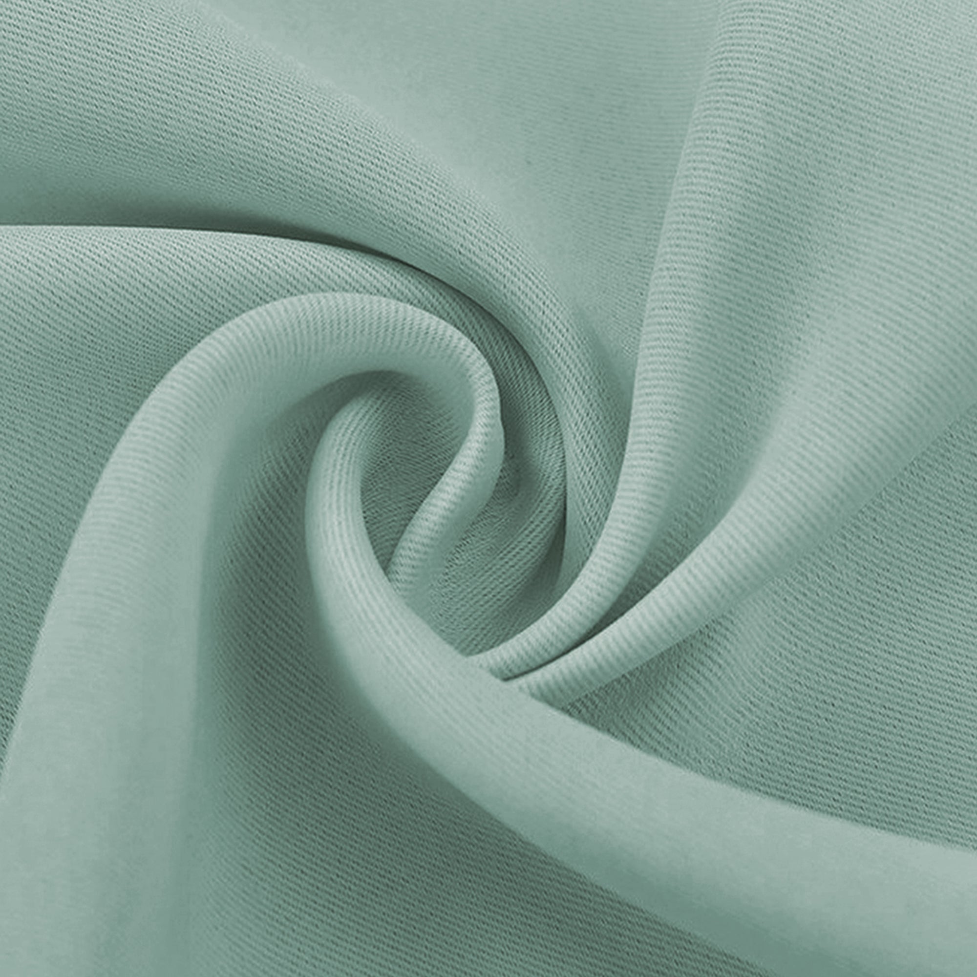 Close-up of a gathered mint green blackout fabric swatch, highlighting its smooth yet finely woven texture and soft folds.