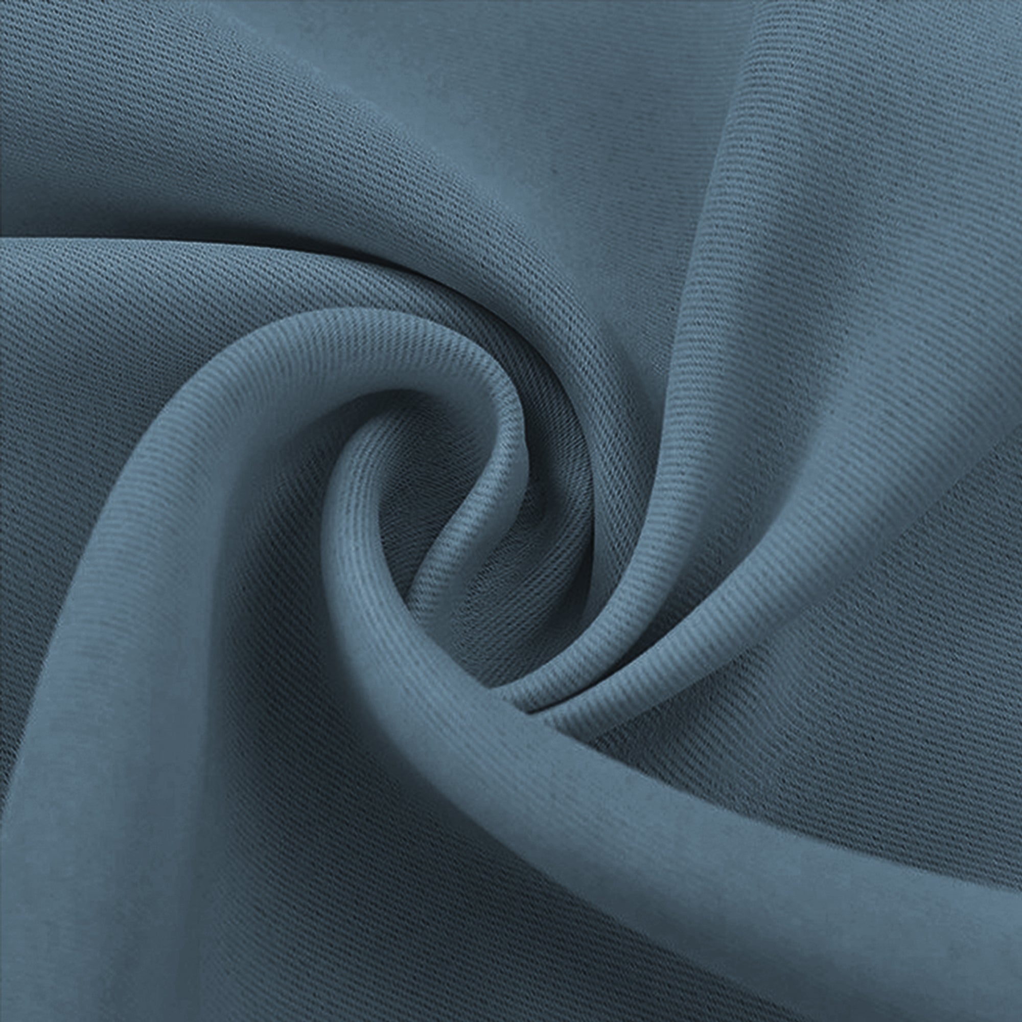 Detailed view of a slate blue blackout fabric swatch, twisted to highlight its tight weave and textured surface.