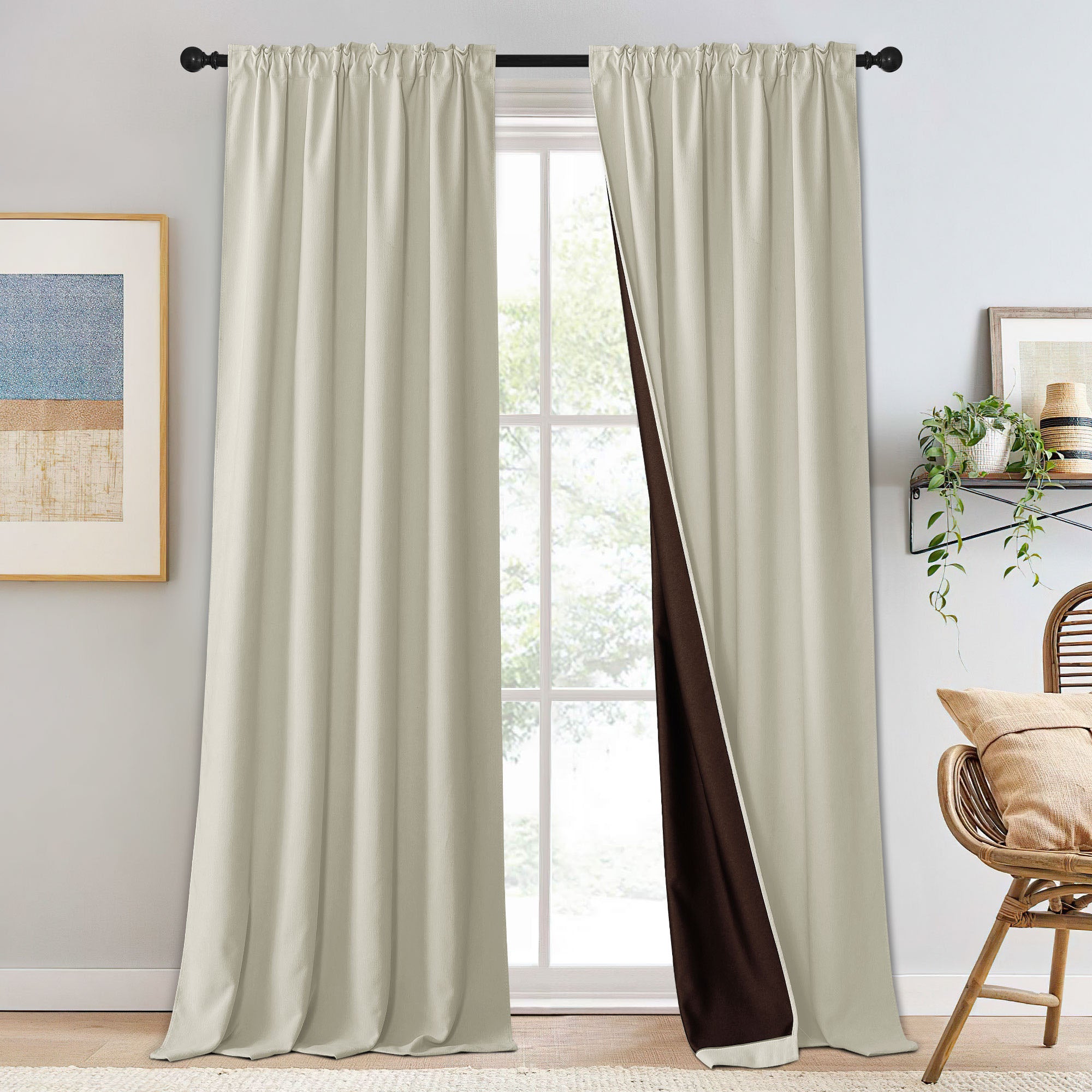 Pair of beige chenille blackout curtains on a rod, with one panel slightly open to reveal the dark brown blackout lining.
