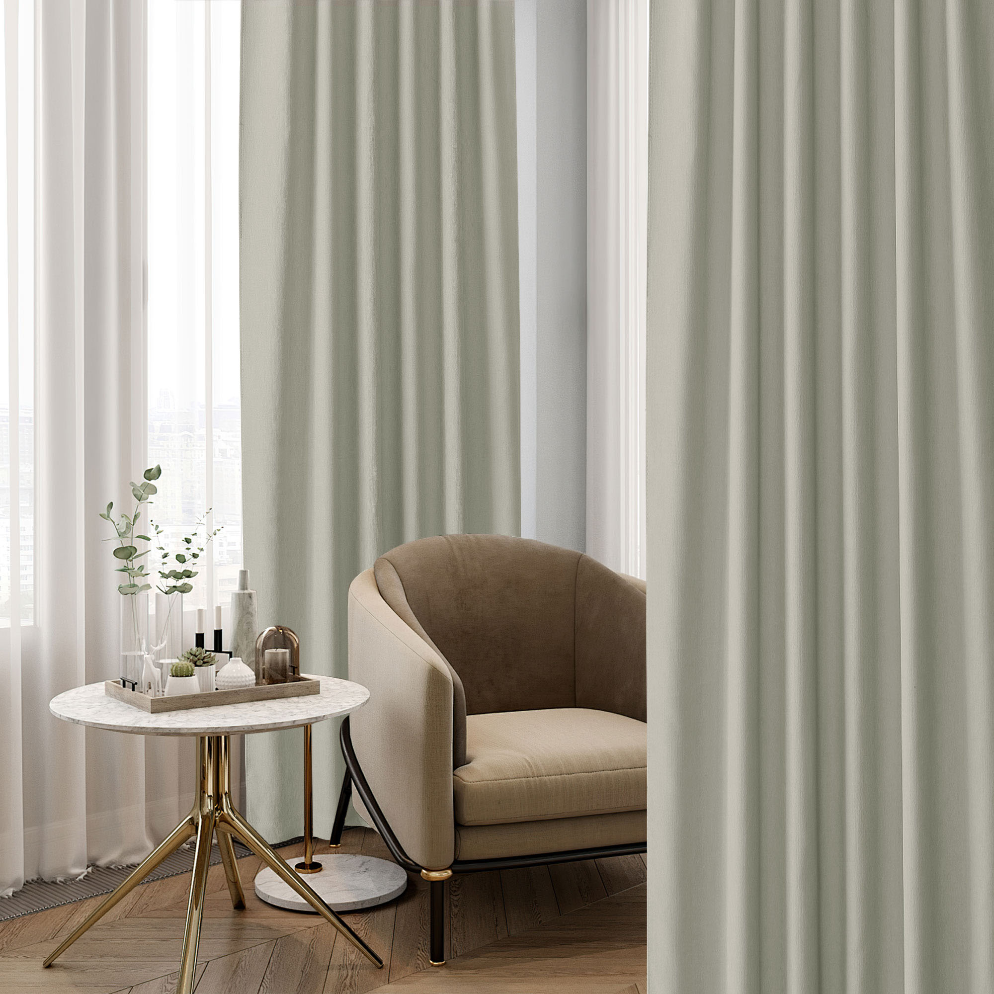 Textured sage green chenille blackout curtain hanging in a modern living space, with a sheer curtain, accent chair, and side table.
