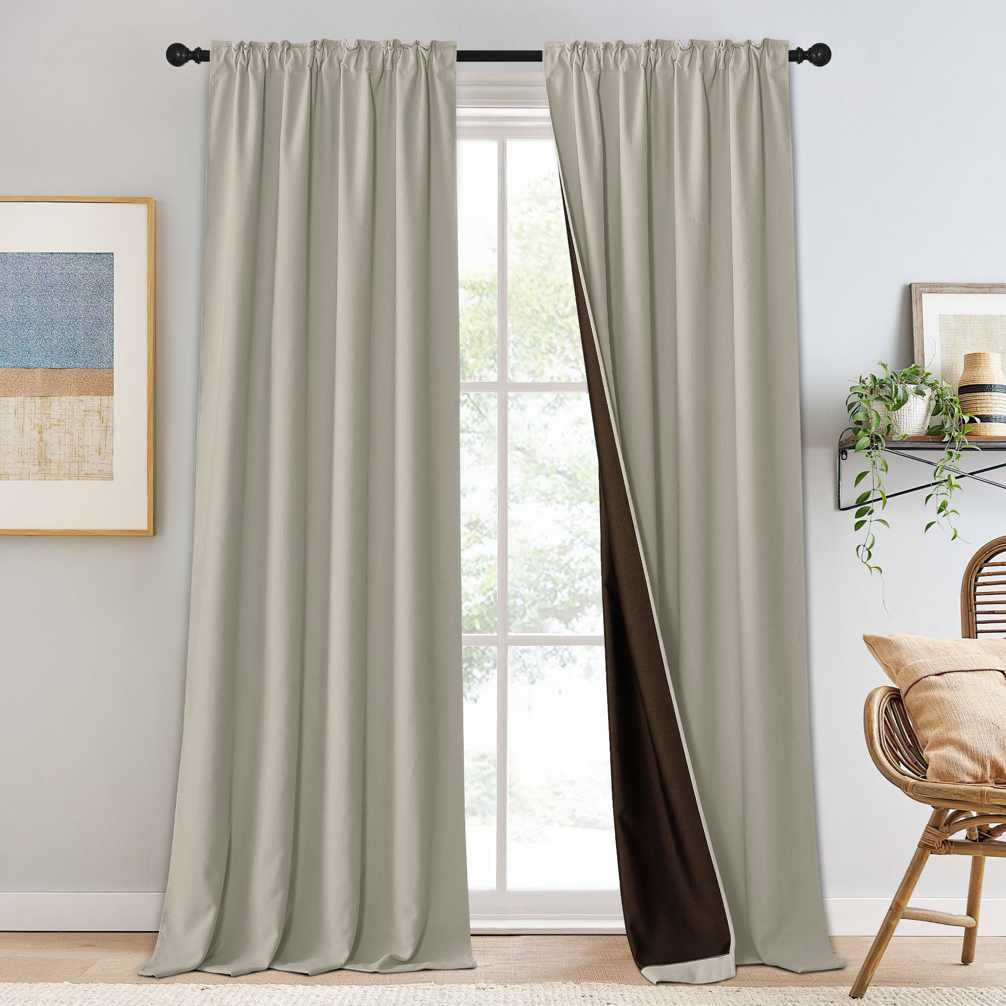 Pair of light beige chenille blackout curtains on a rod, one panel slightly open to reveal the dark brown lining.