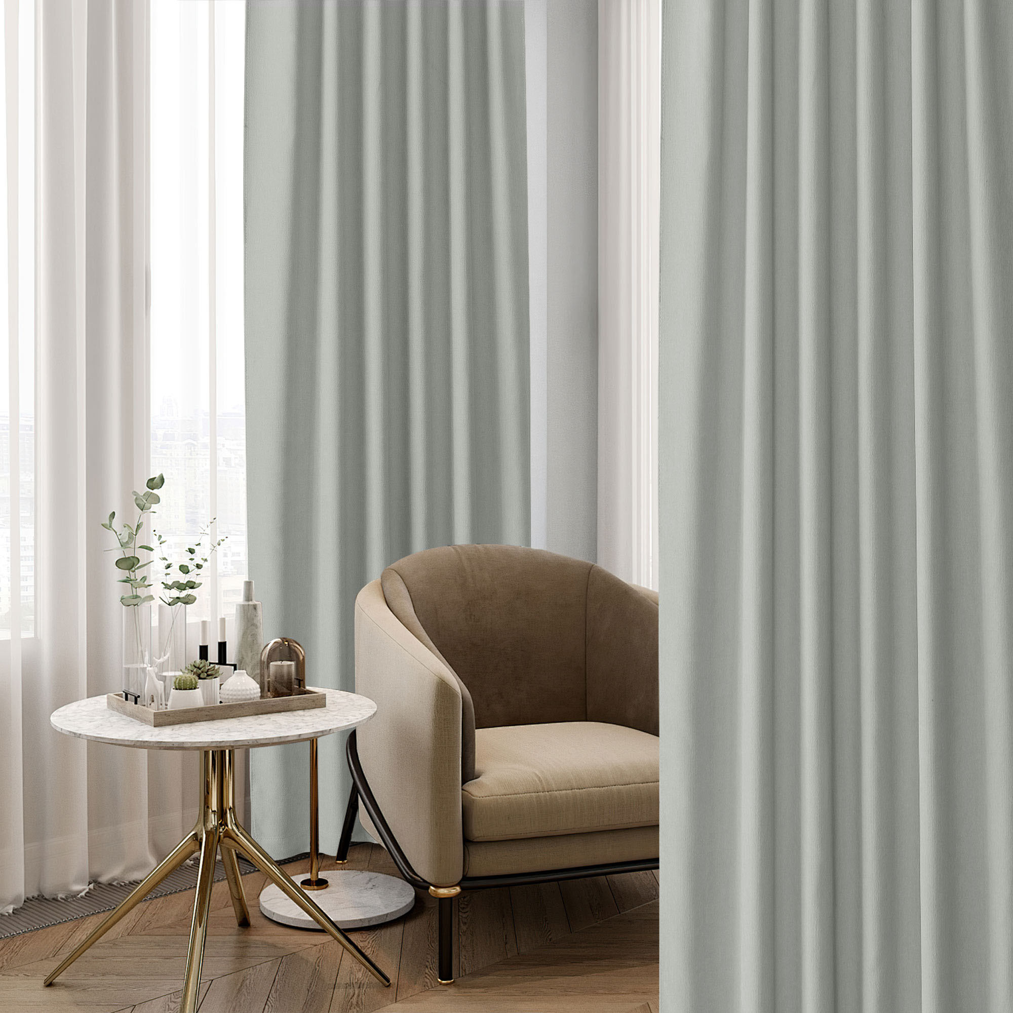 Light grey-green chenille blackout curtains showcasing the fabric texture and drapes, alongside a stylish armchair and side table.