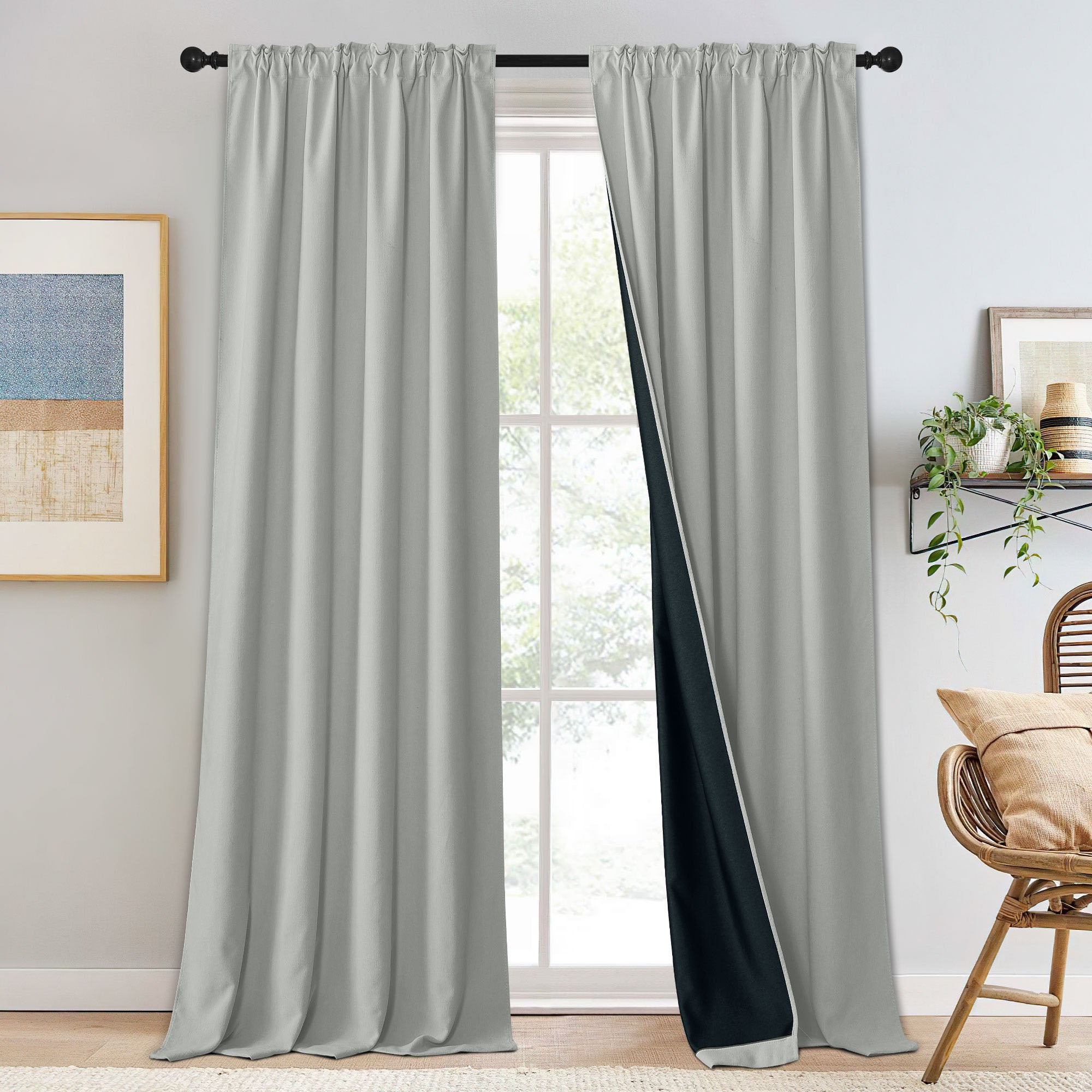 Light grey chenille blackout curtains with black lining, one panel slightly open, showing rod pocket style on a window.
