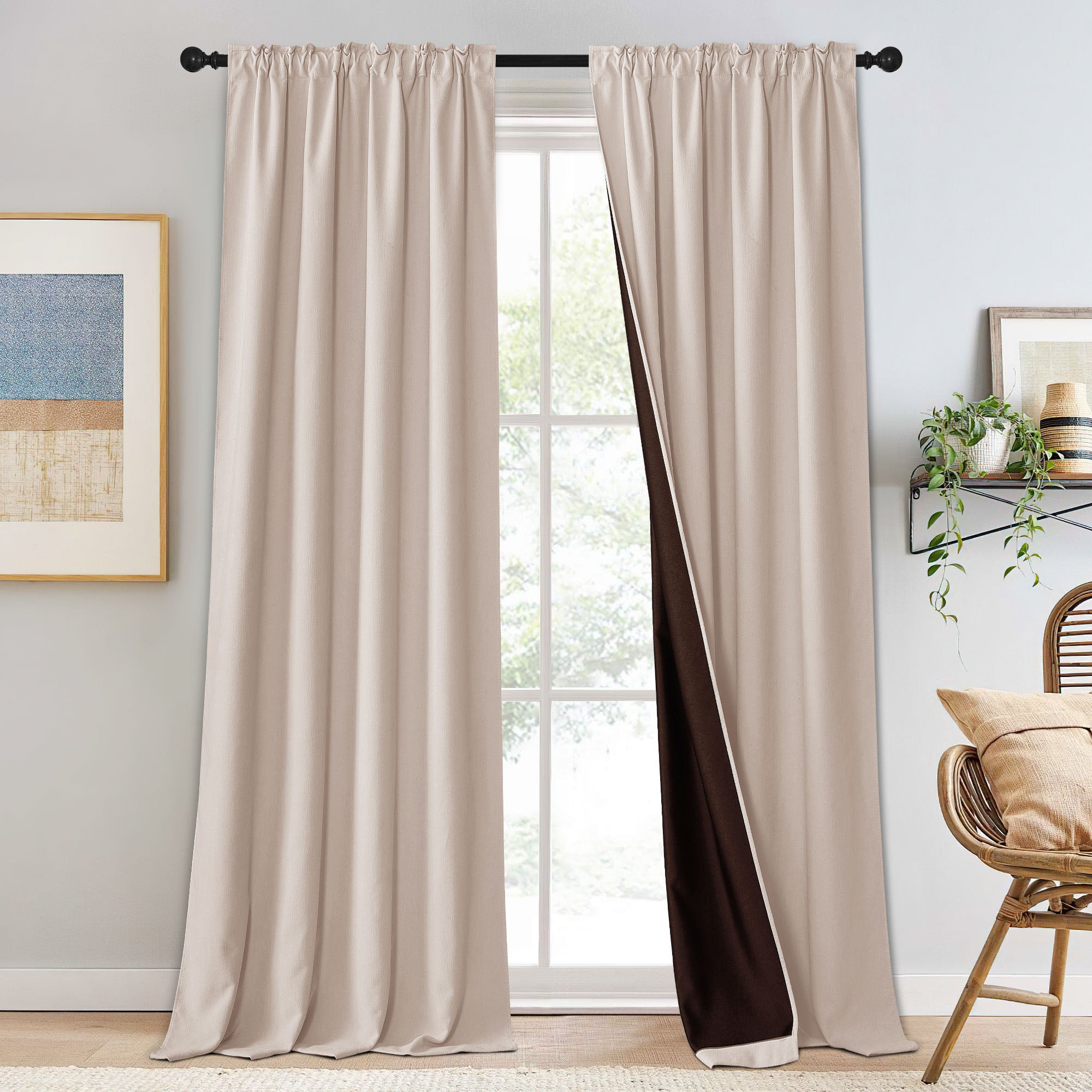 Beige chenille blackout curtains on a rod, one pulled back to reveal dark brown lining, showcasing room darkening ability.